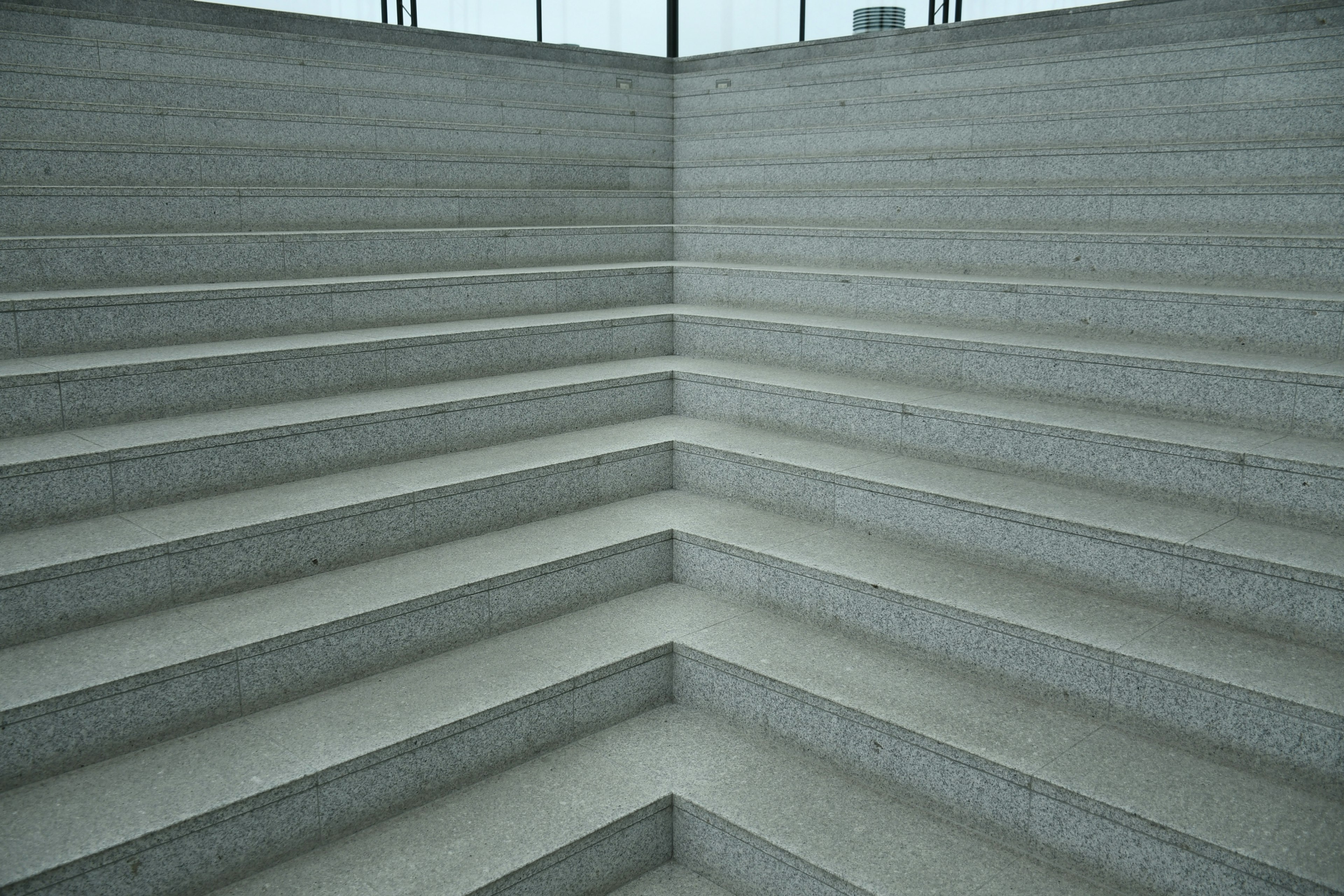 Simple design of concrete stairs intersecting in an indoor space