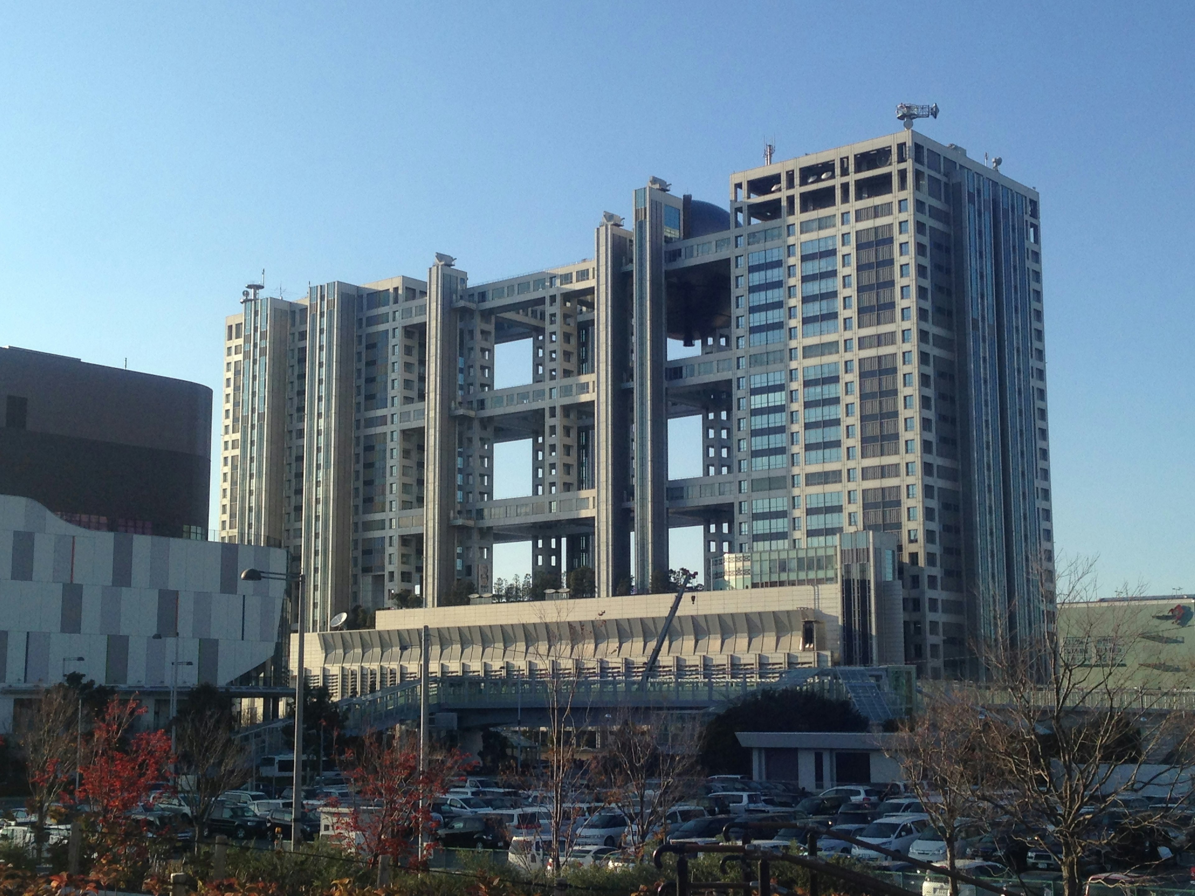 Futuristic architectural building with large cutouts against a clear blue sky