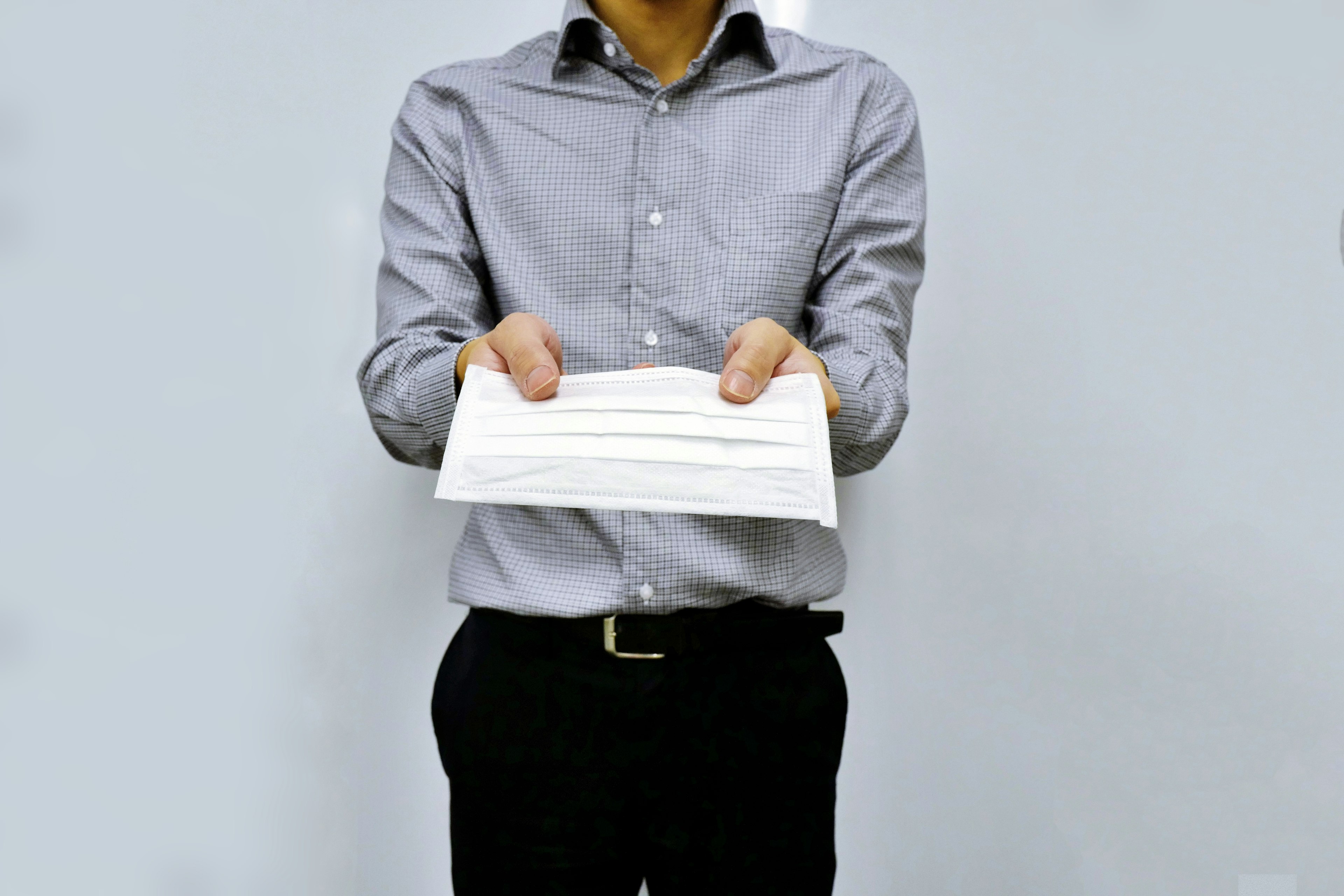 Man holding a white sheet of paper