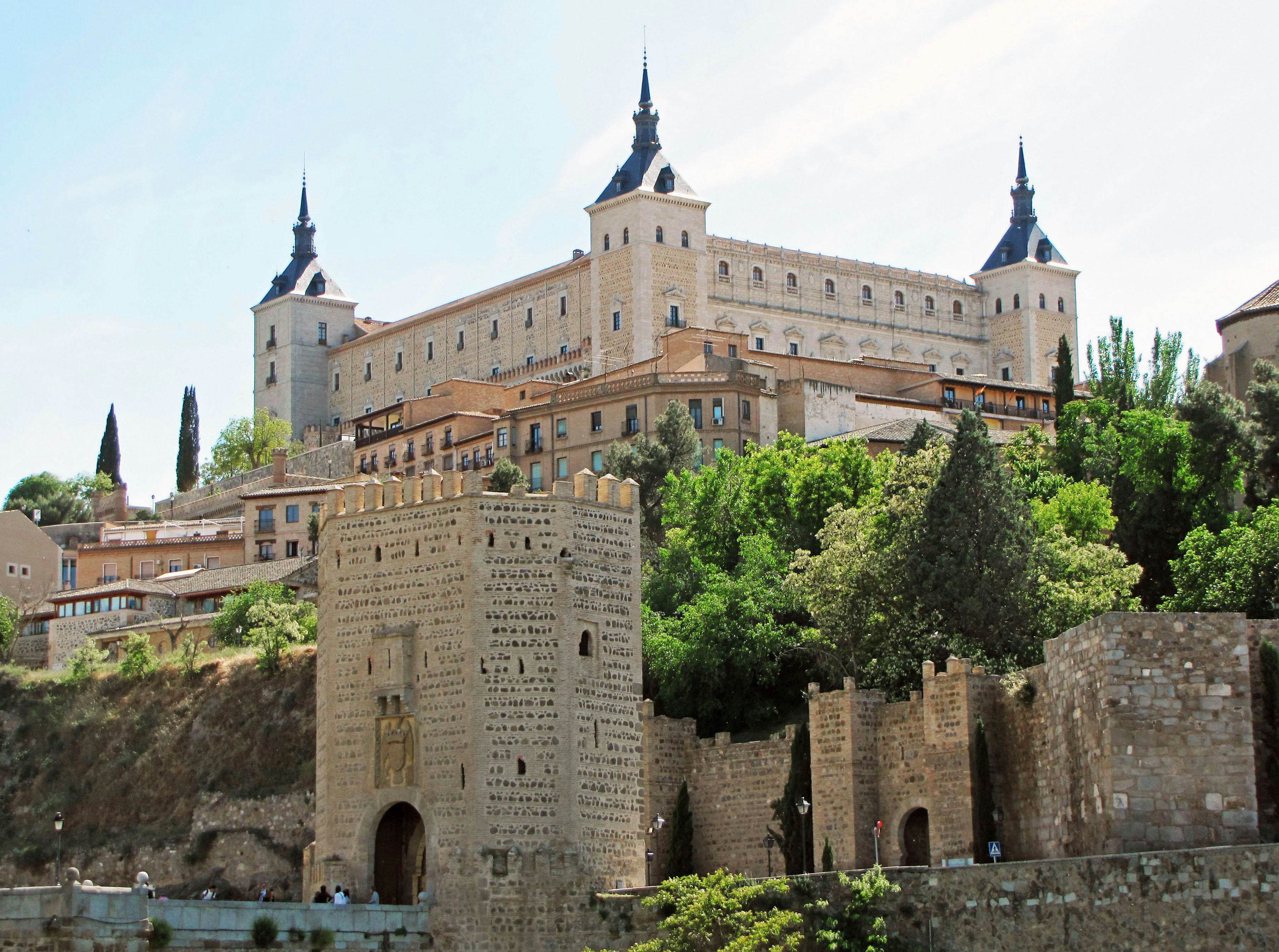 The Alcázar of Toledo surrounded by lush greenery