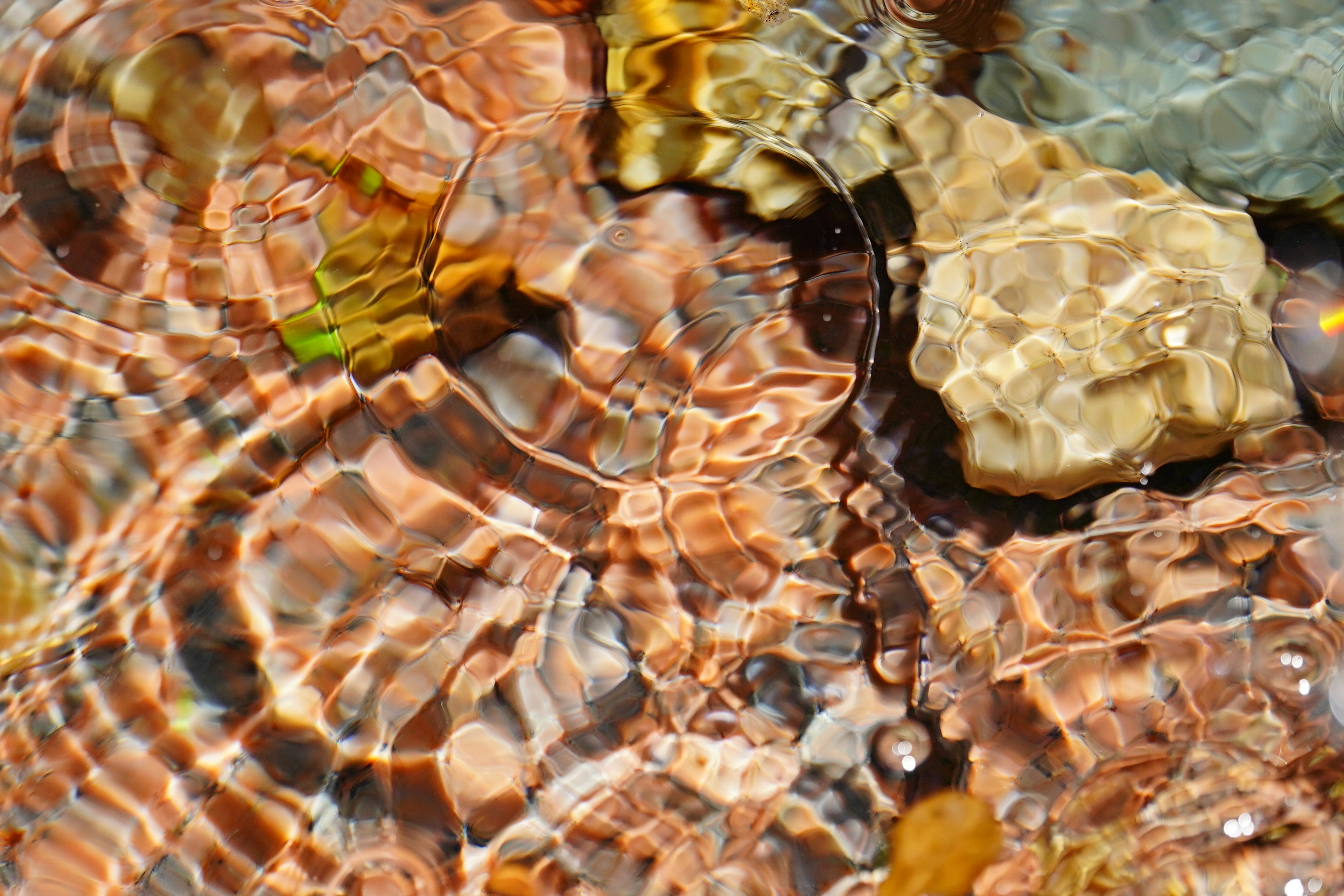 Beautiful patterns of stones and ripples reflected on the water surface