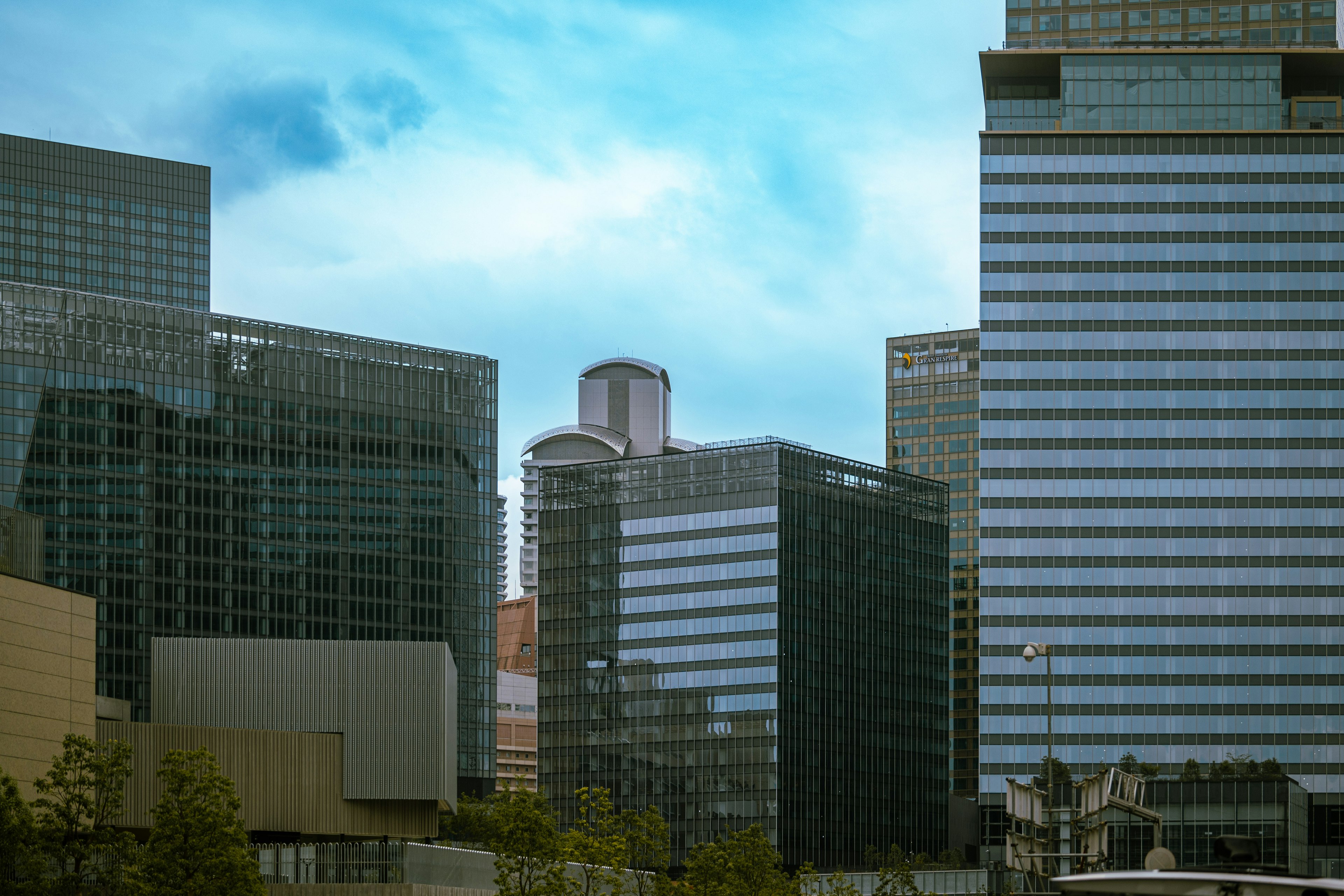 Stadtansicht mit hohen Wolkenkratzern unter blauem Himmel und Wolken