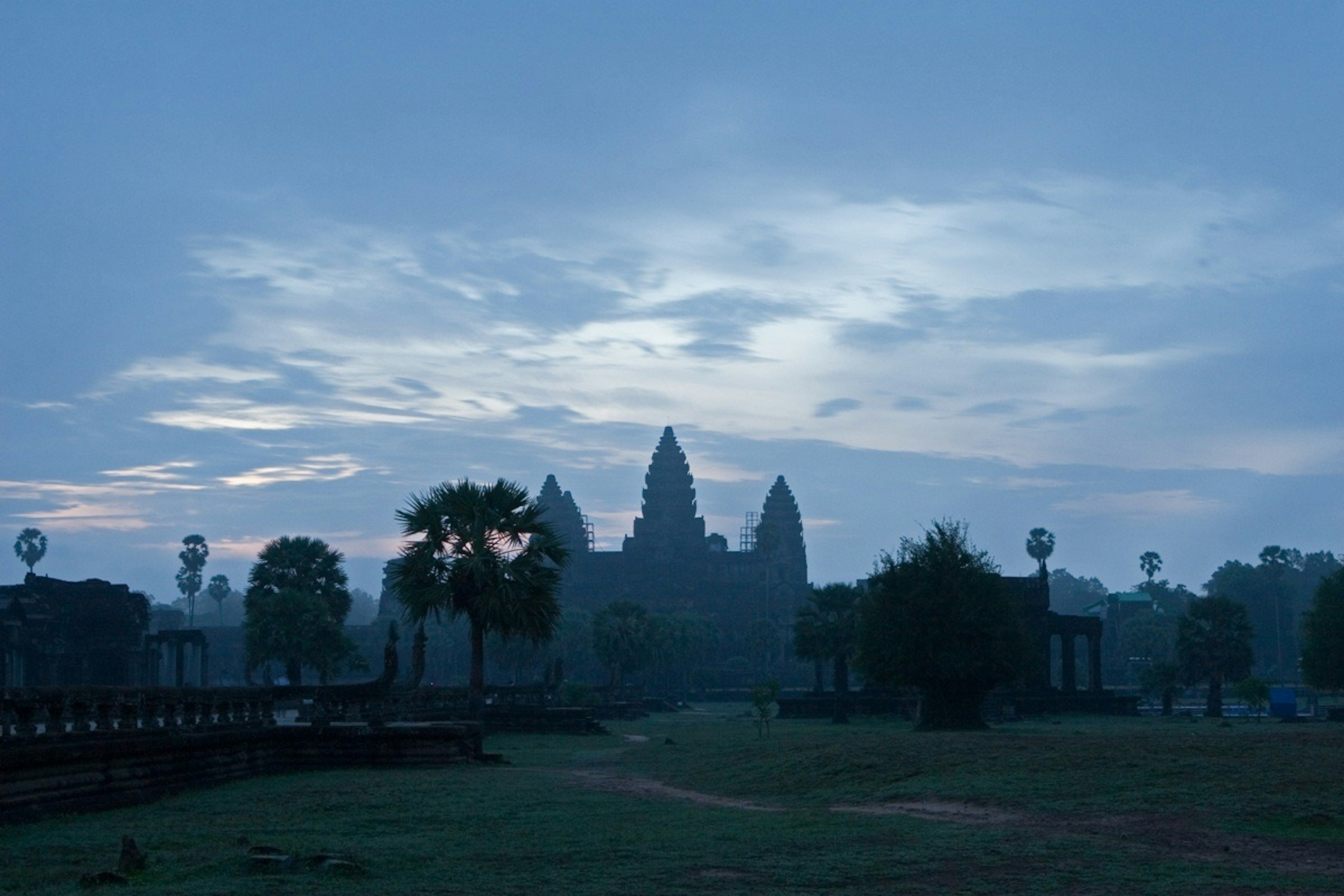 Silhouette d'Angkor Wat à l'aube avec un paysage brumeux