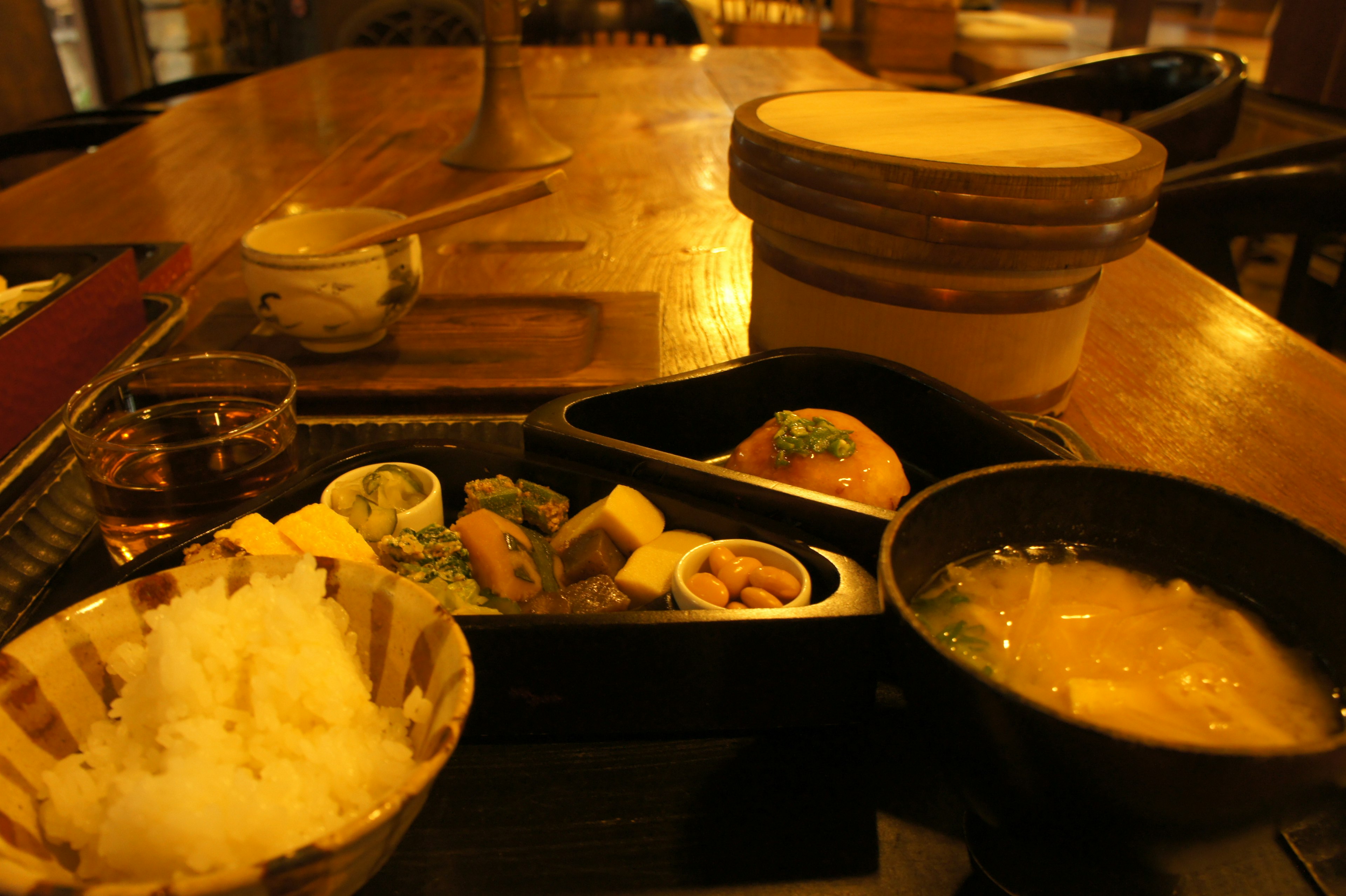 A beautifully arranged Japanese lunch plate featuring rice miso soup and small side dishes