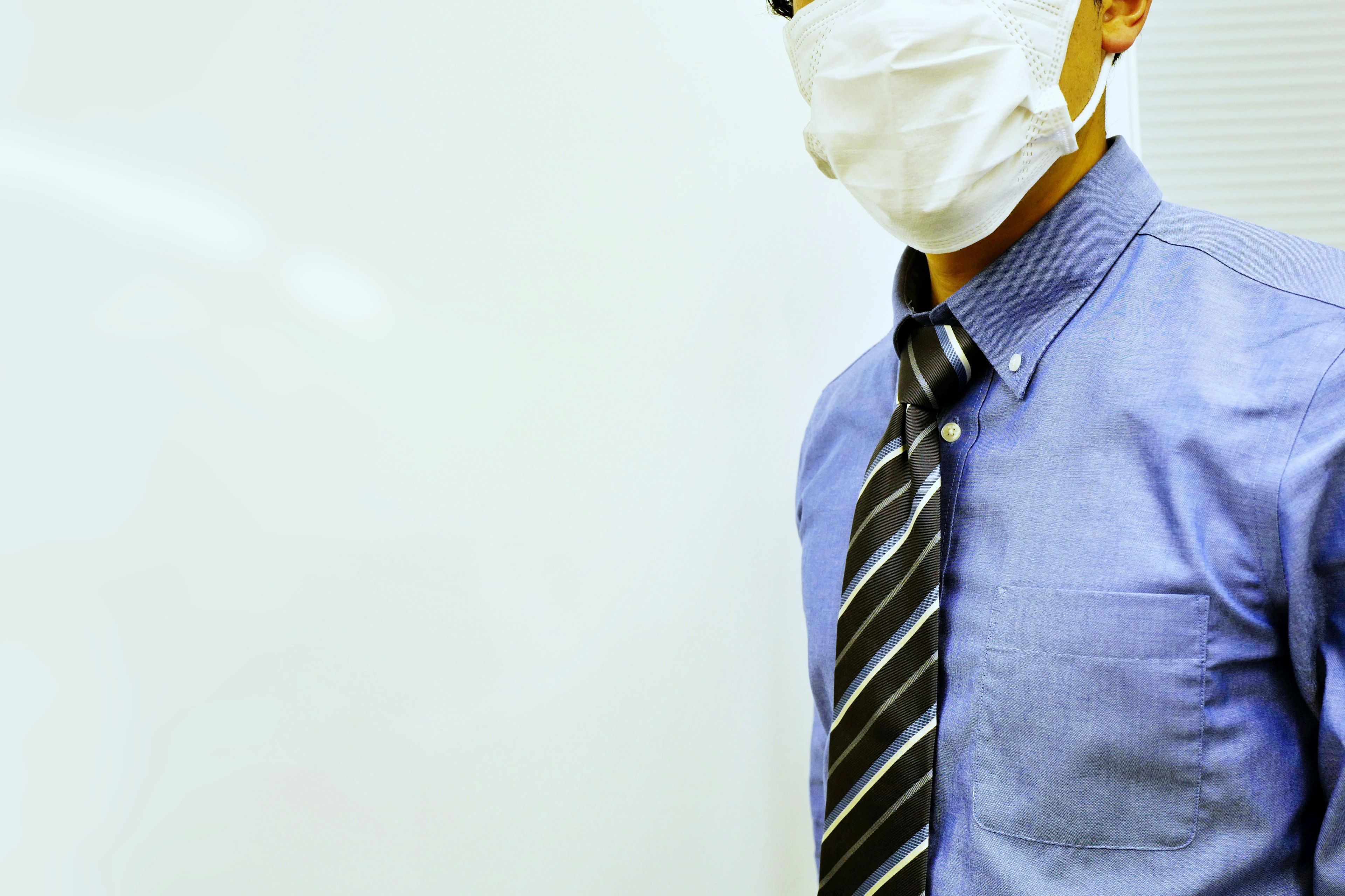 Businessman wearing a mask in a formal shirt and tie