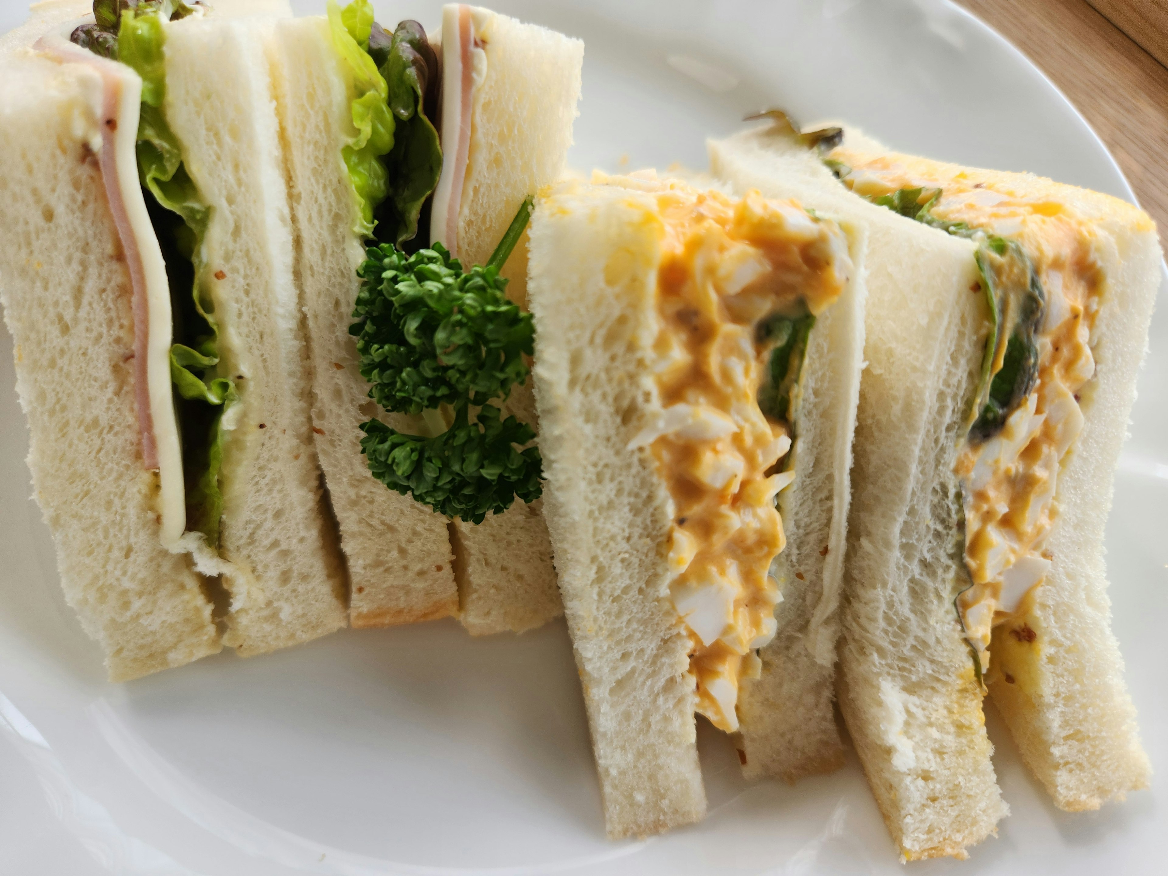 Assorted sandwiches with lettuce and broccoli filling creamy egg salad