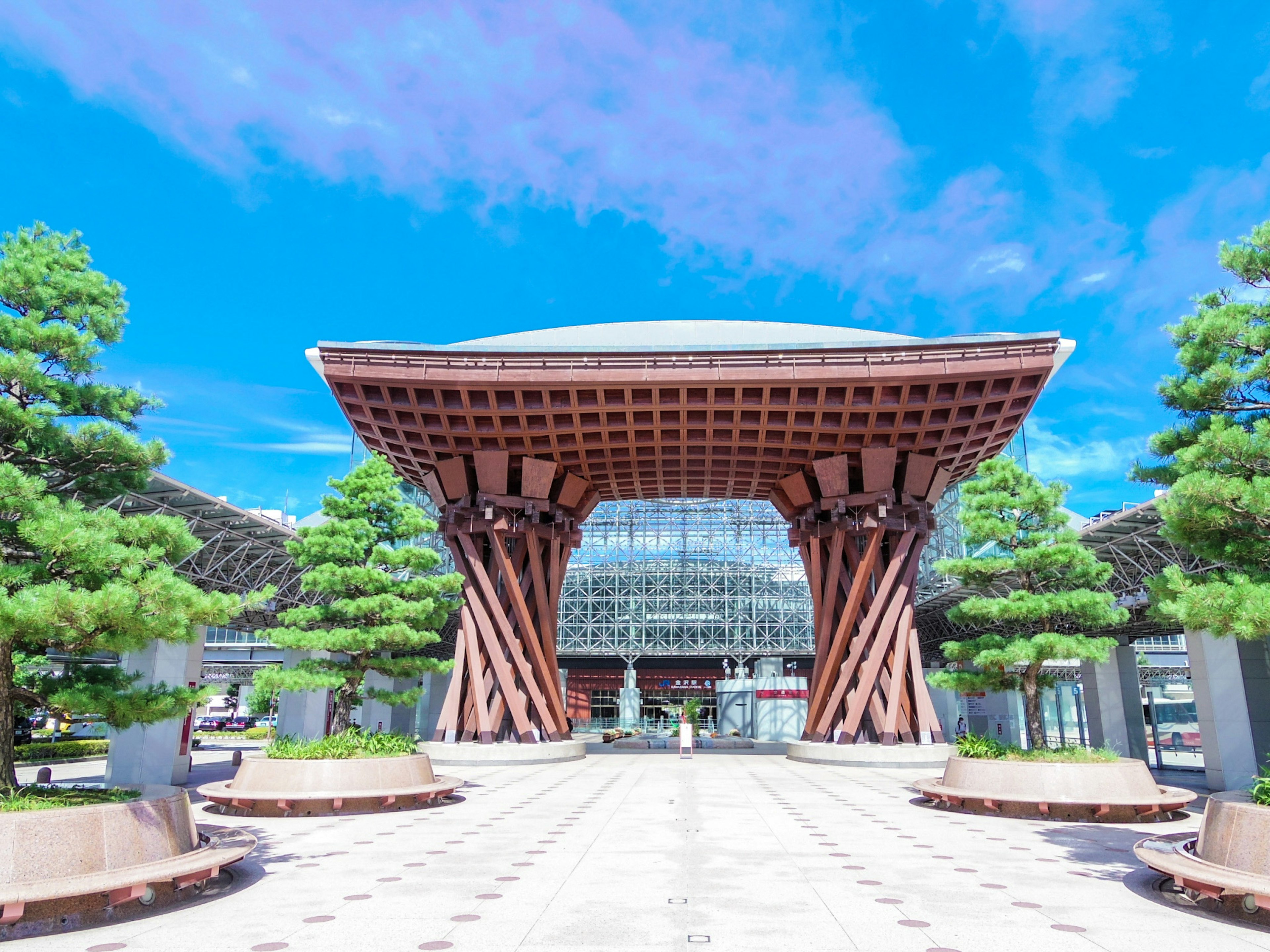 Eksterior stasiun yang indah dengan arsitektur modern dan pohon hijau