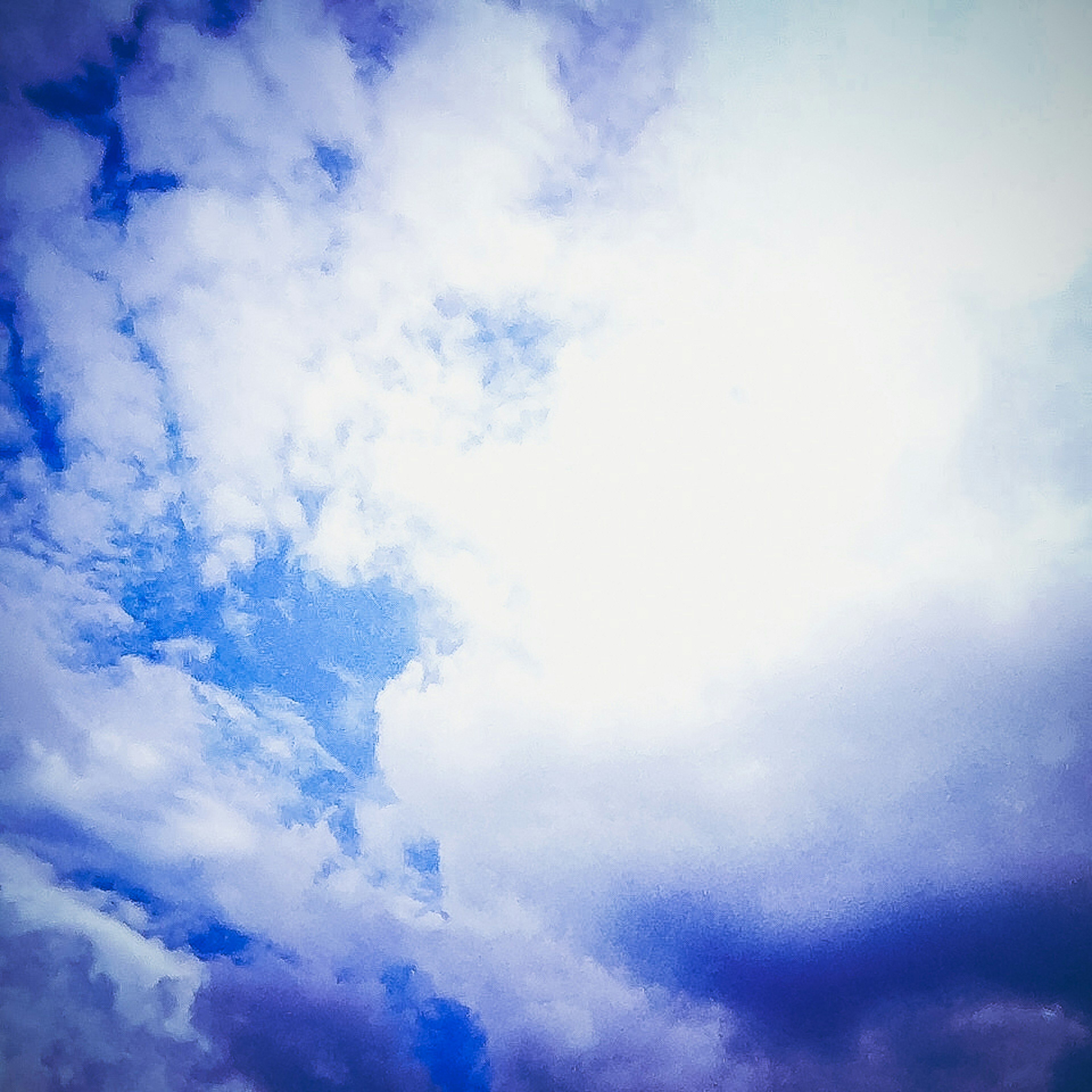 A landscape with blue sky and white clouds