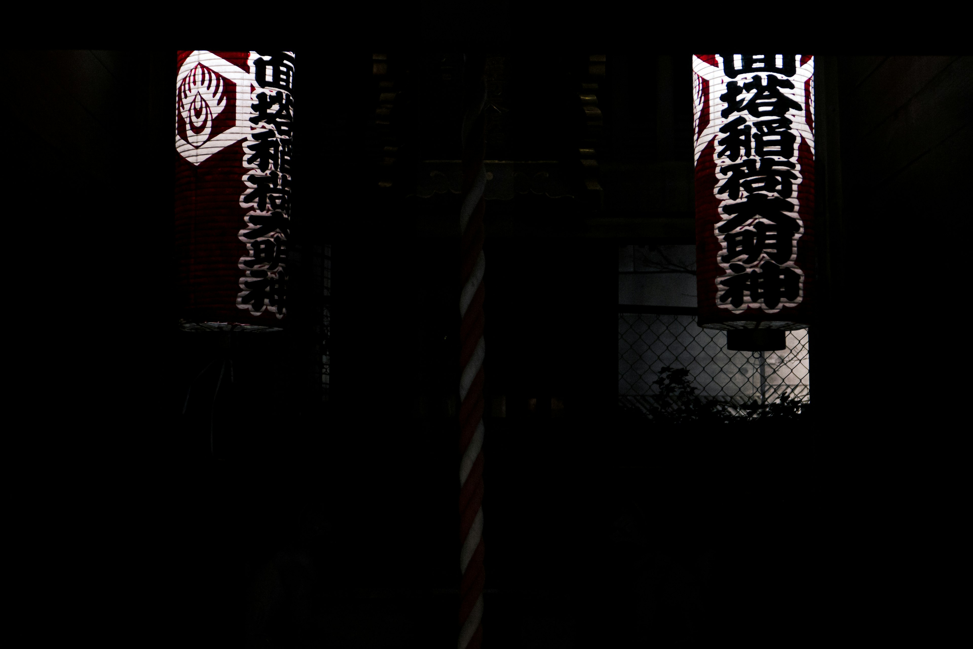 White lanterns with Japanese characters against a dark background