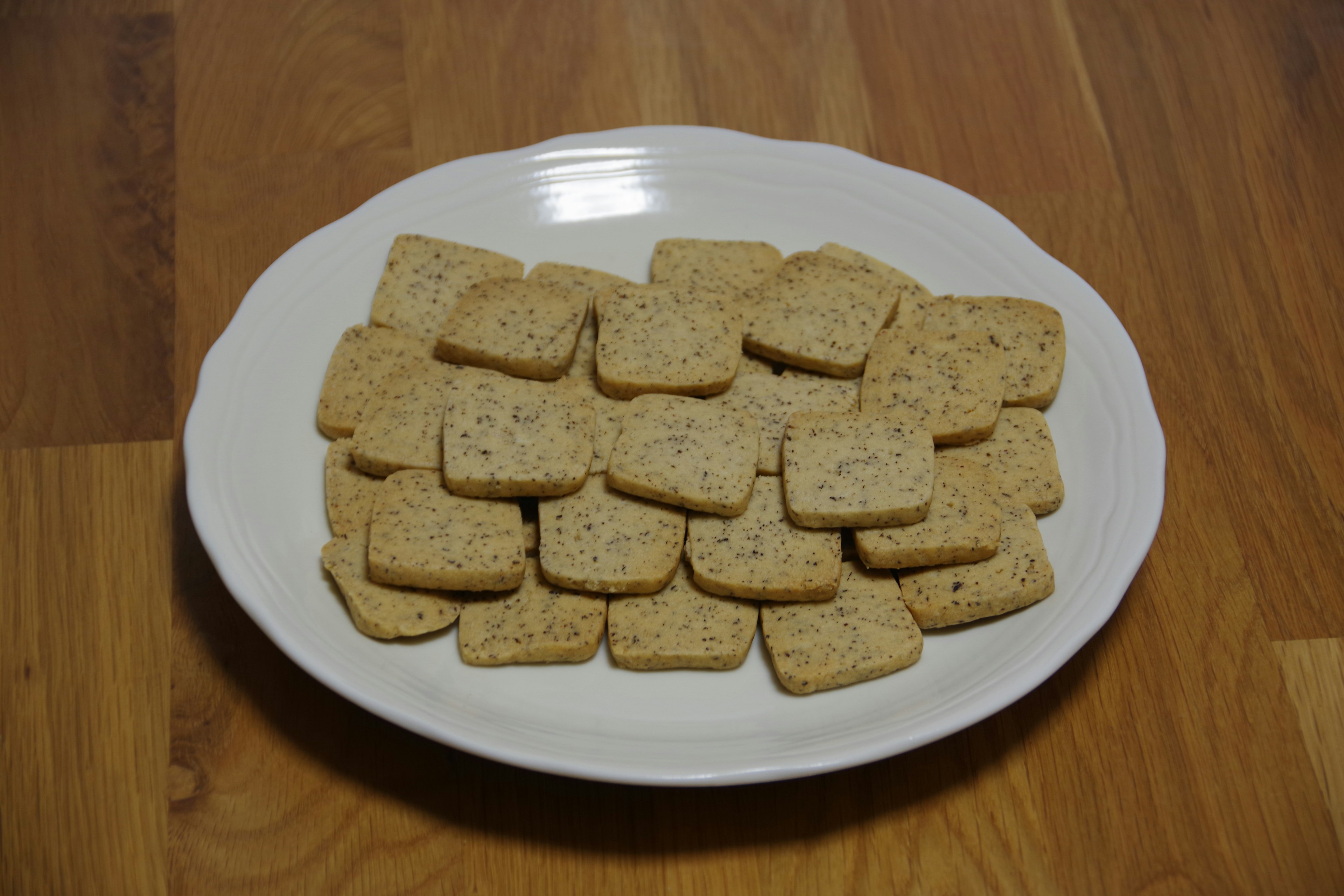 Square biscuits arranged on a white plate