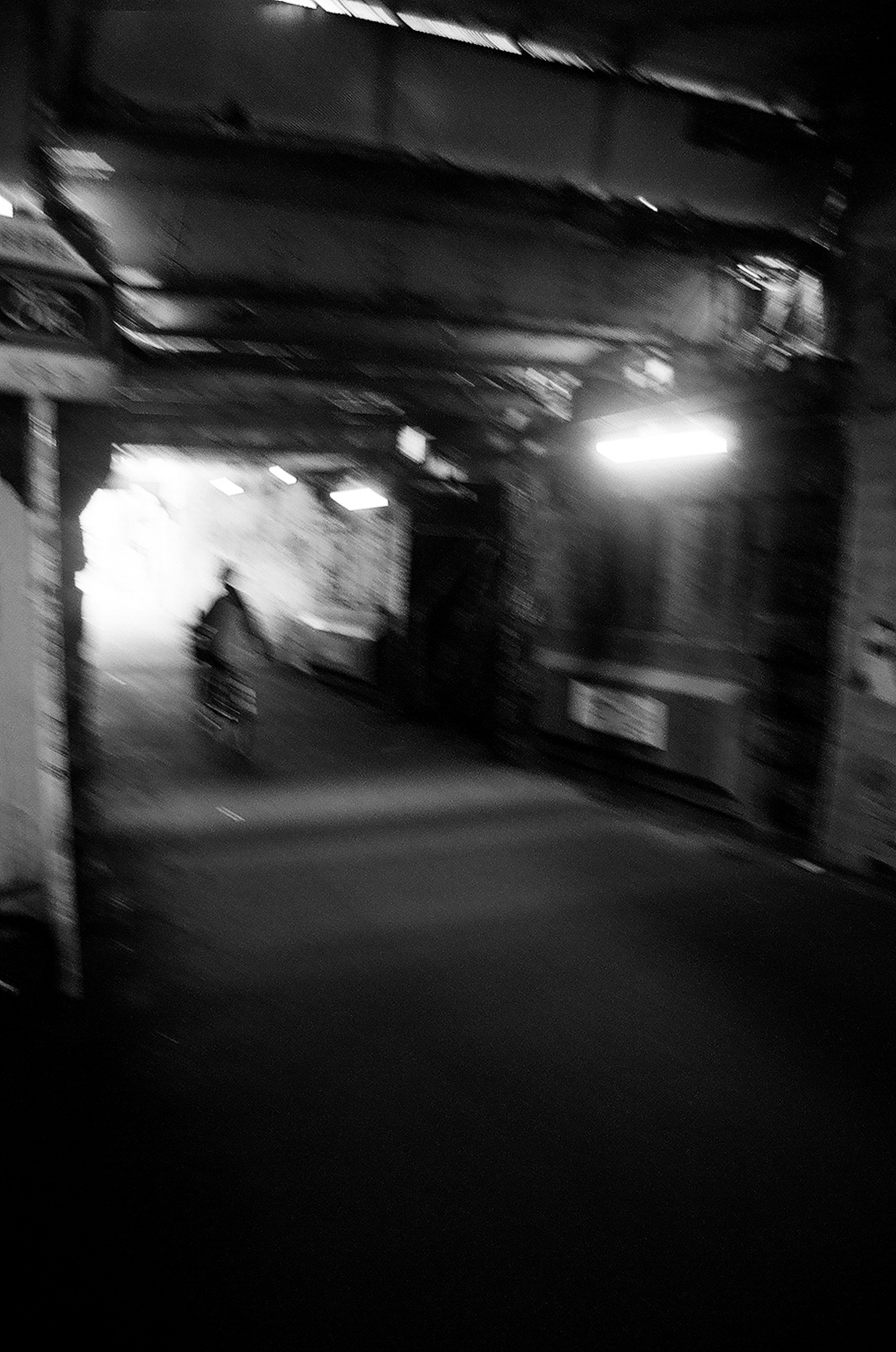 Shadow of a bicycle moving through a dimly lit tunnel