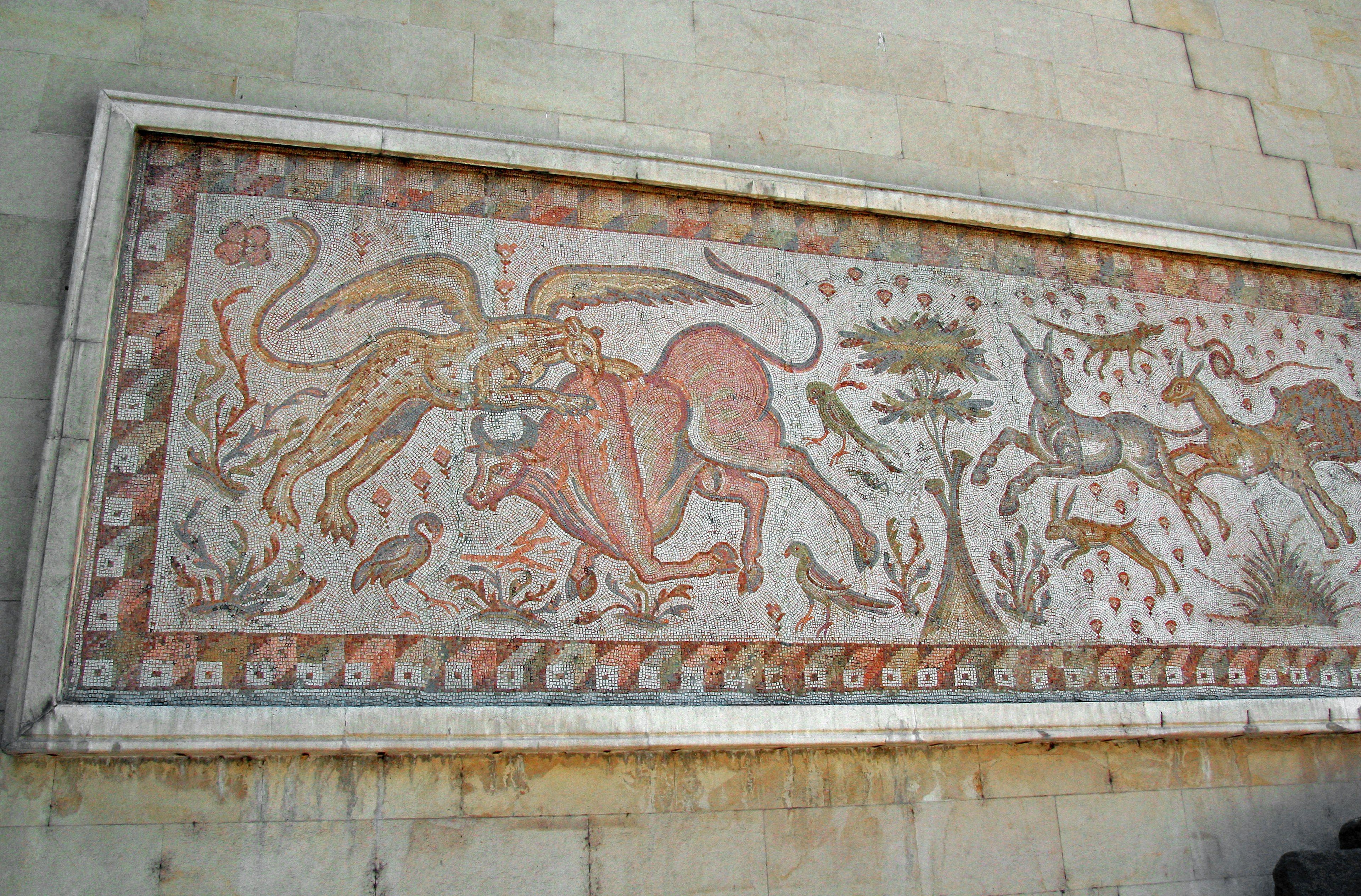 Ancient mosaic art depicting a lion and dragon battling