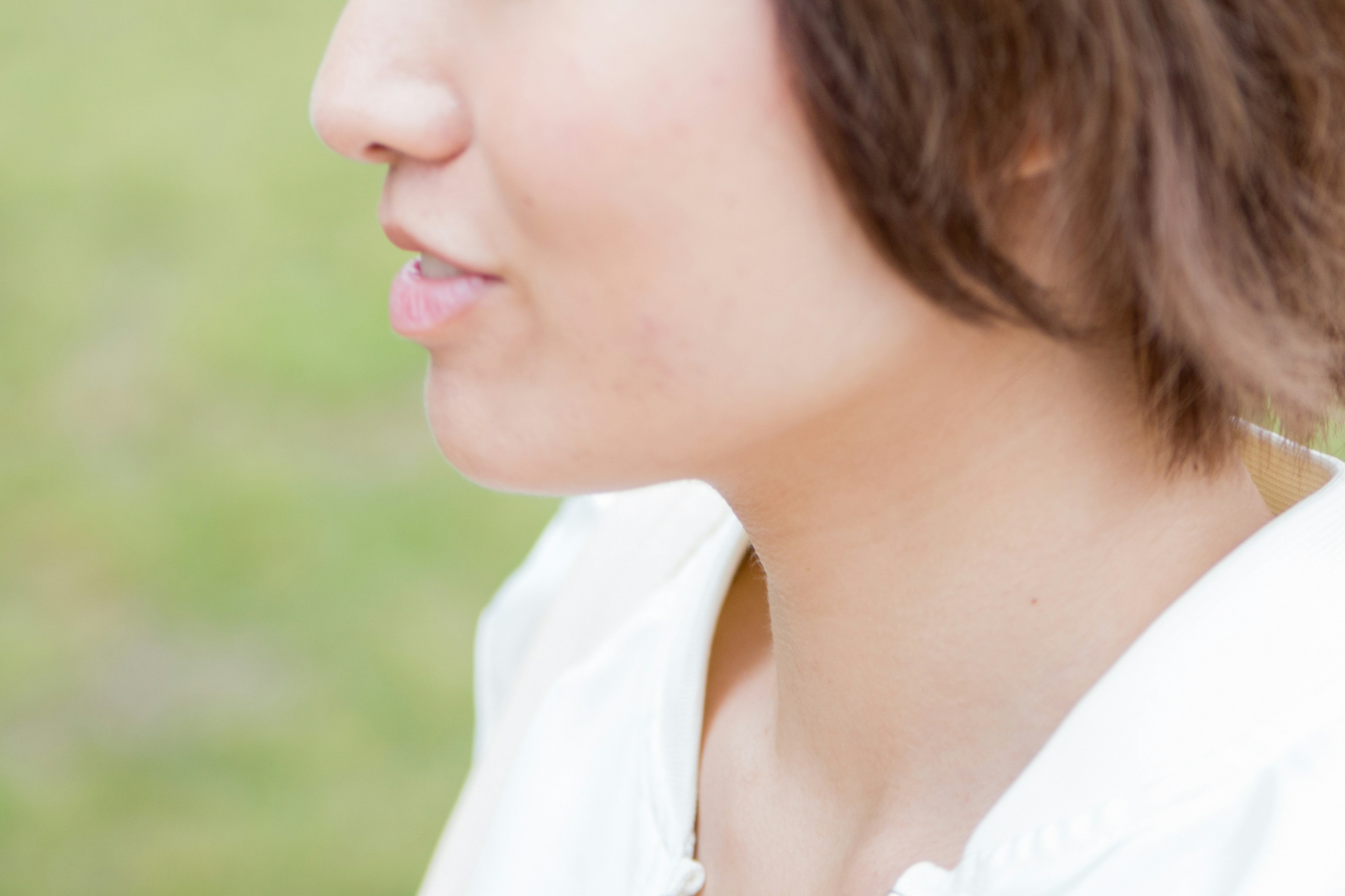 Profile view of a woman smiling outdoors