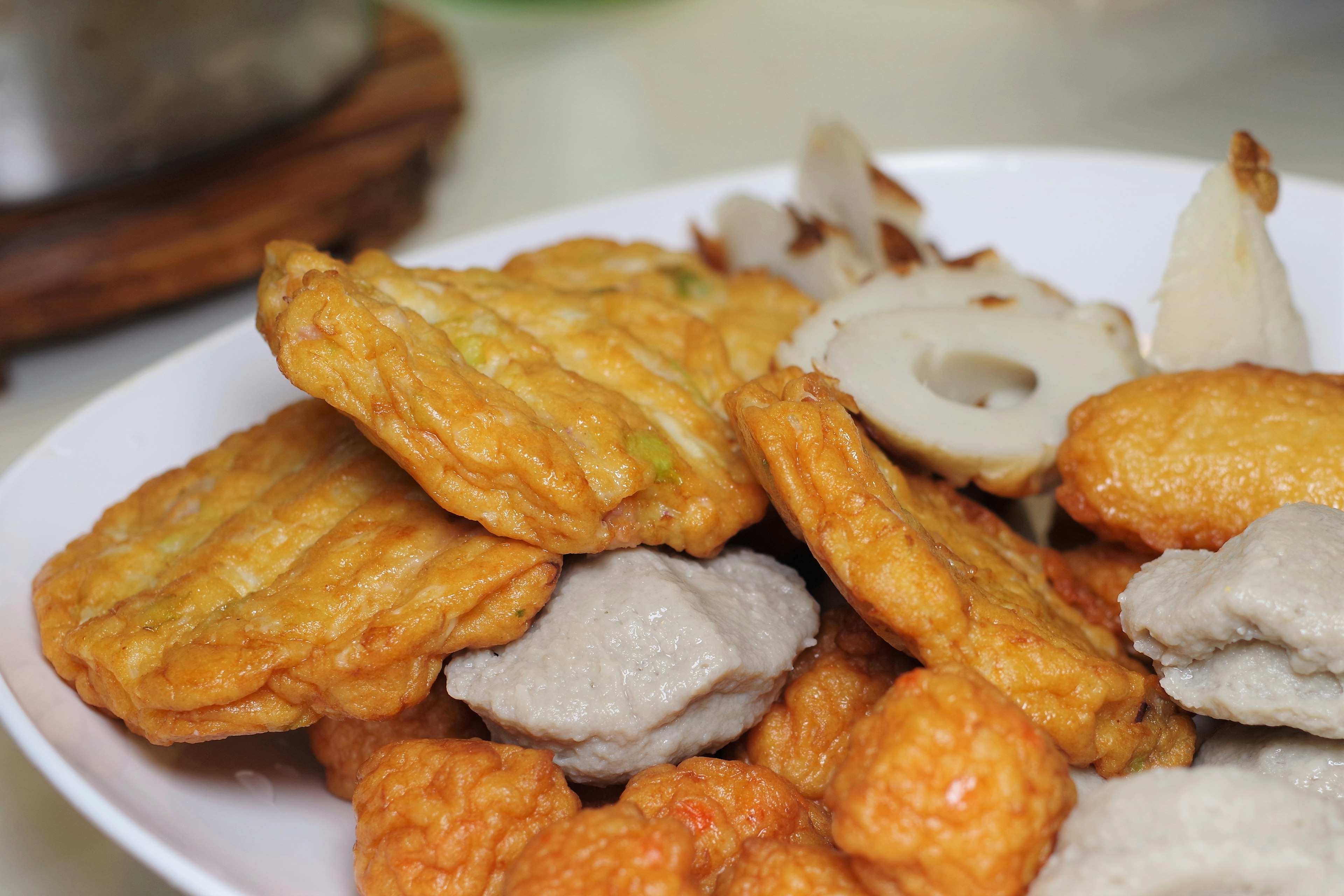 A plate of assorted fried fish cakes and snacks