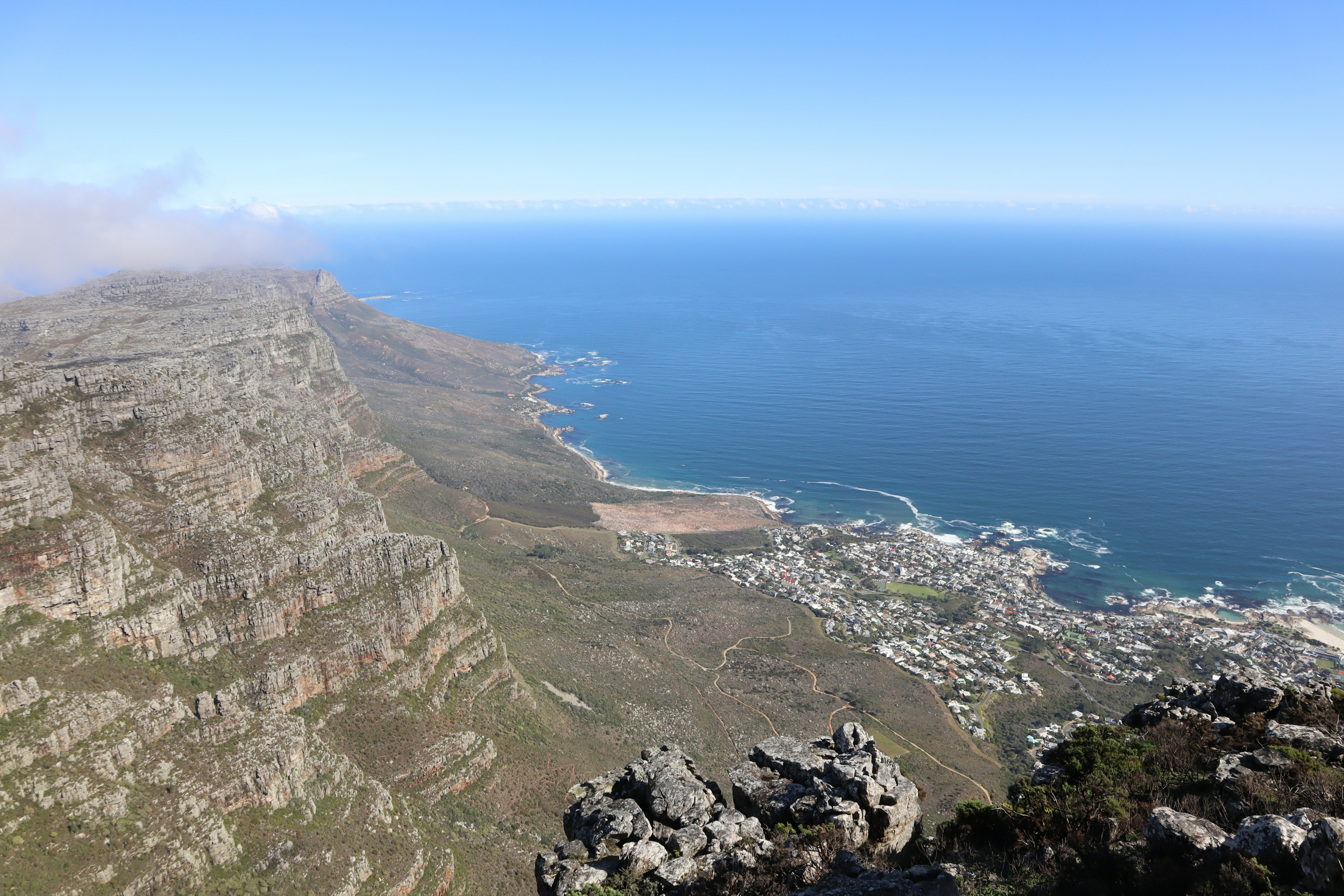 View of the coastline from Table Mountain clear blue sky and beautiful ocean vista