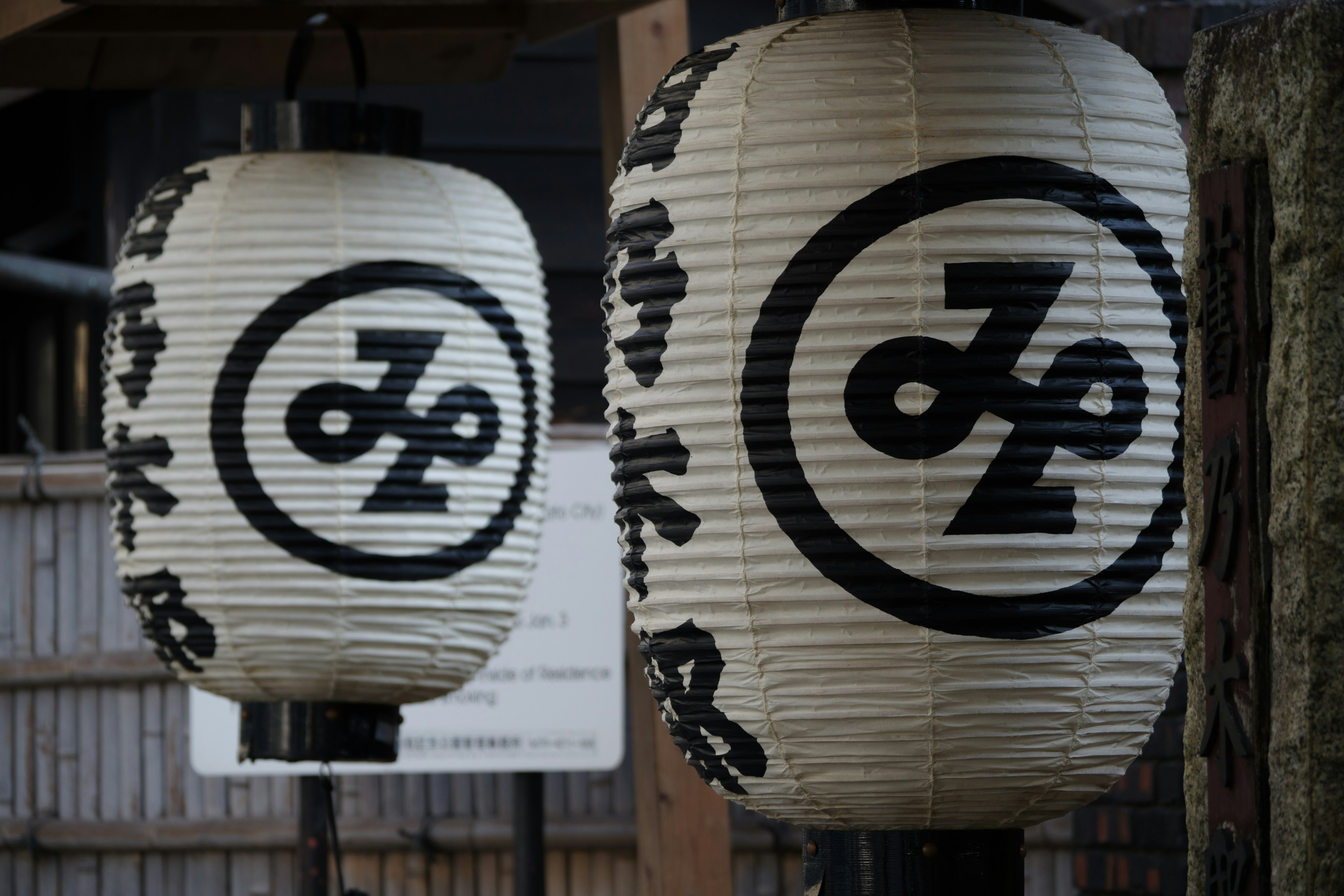 White Japanese lanterns with black logo designs