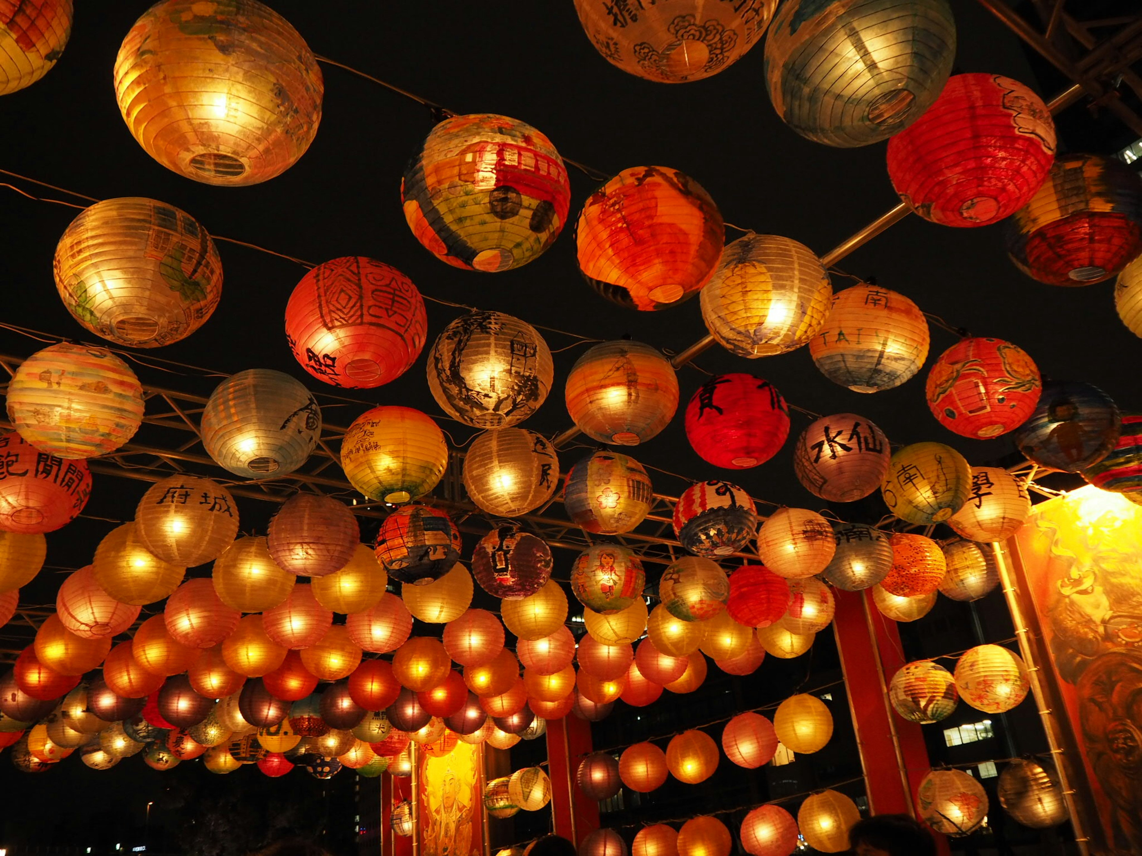 Colorful lanterns hanging in the night sky