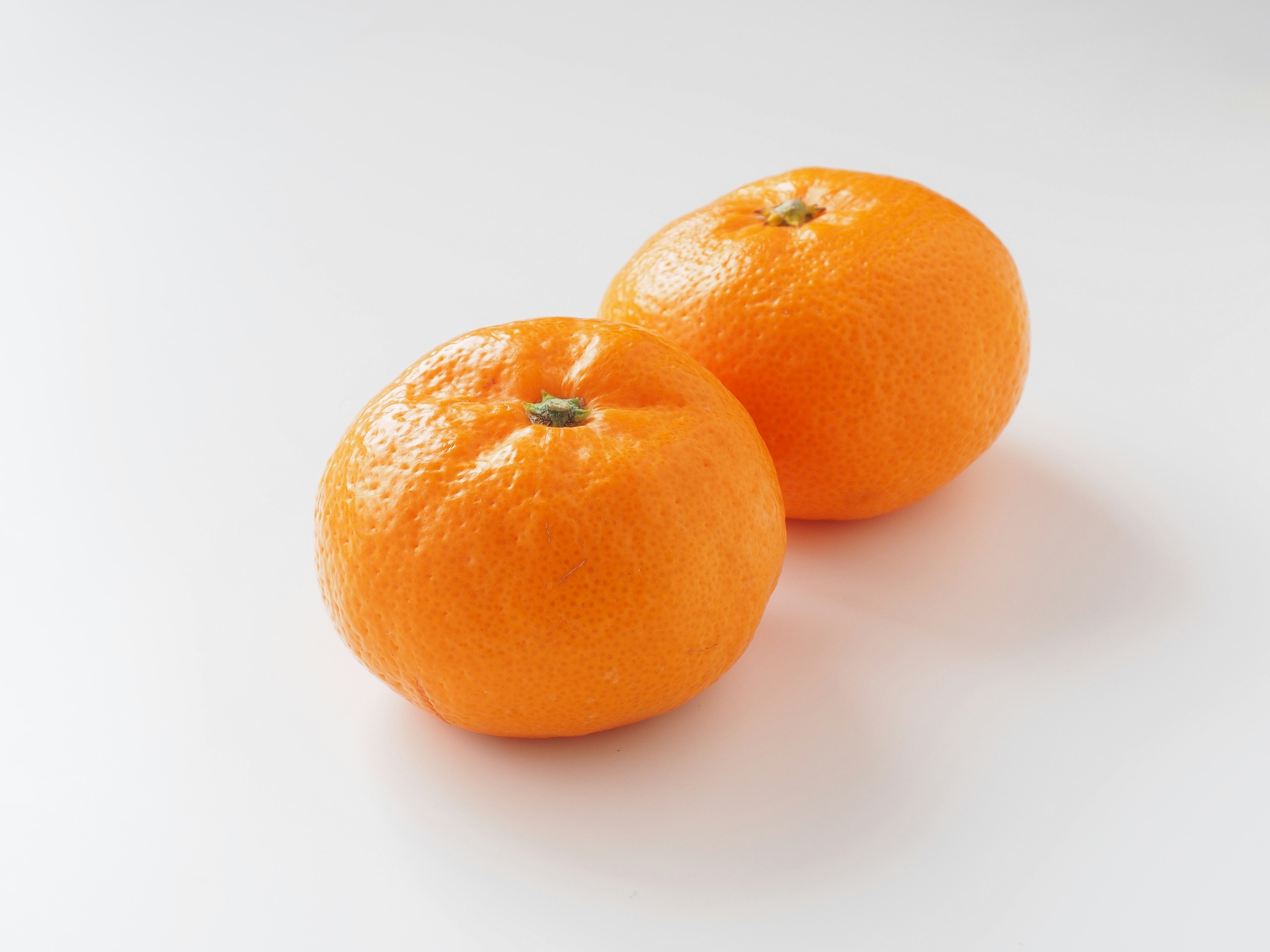 Two oranges on a white background