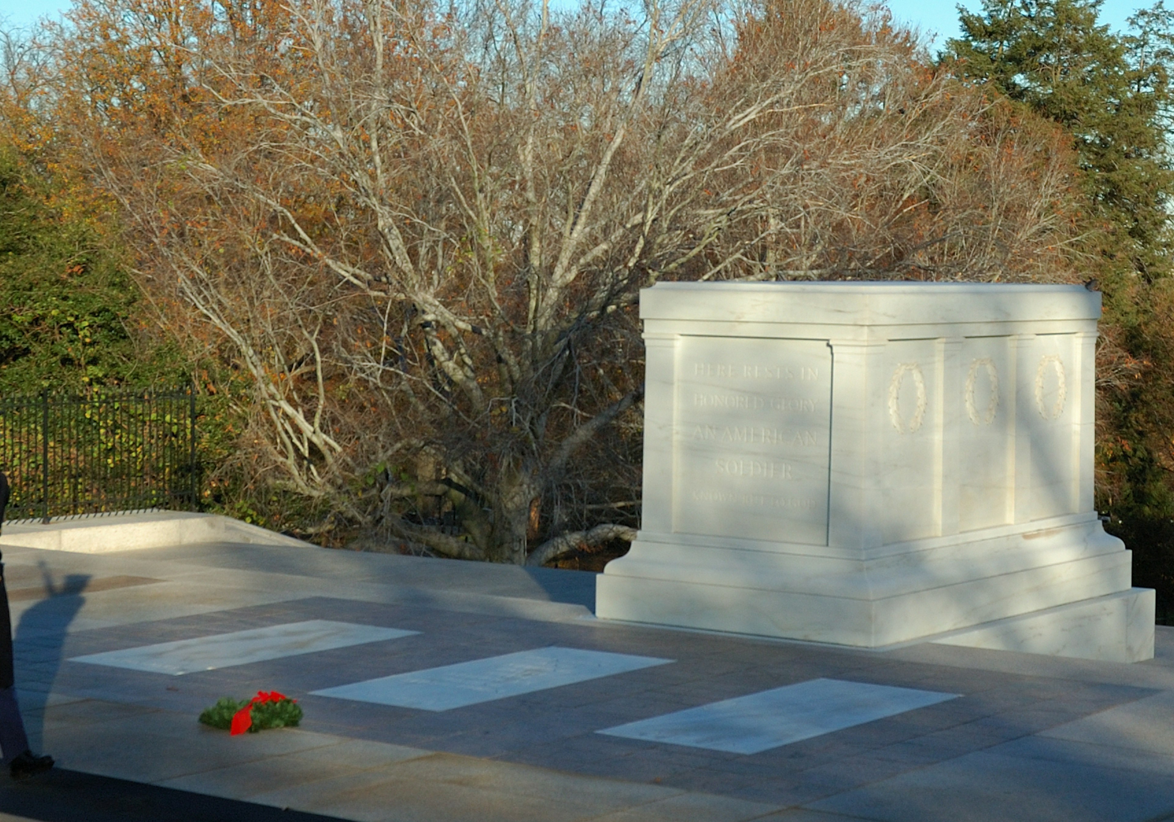 White monument of the Tomb of the Unknown Soldier surrounded by trees