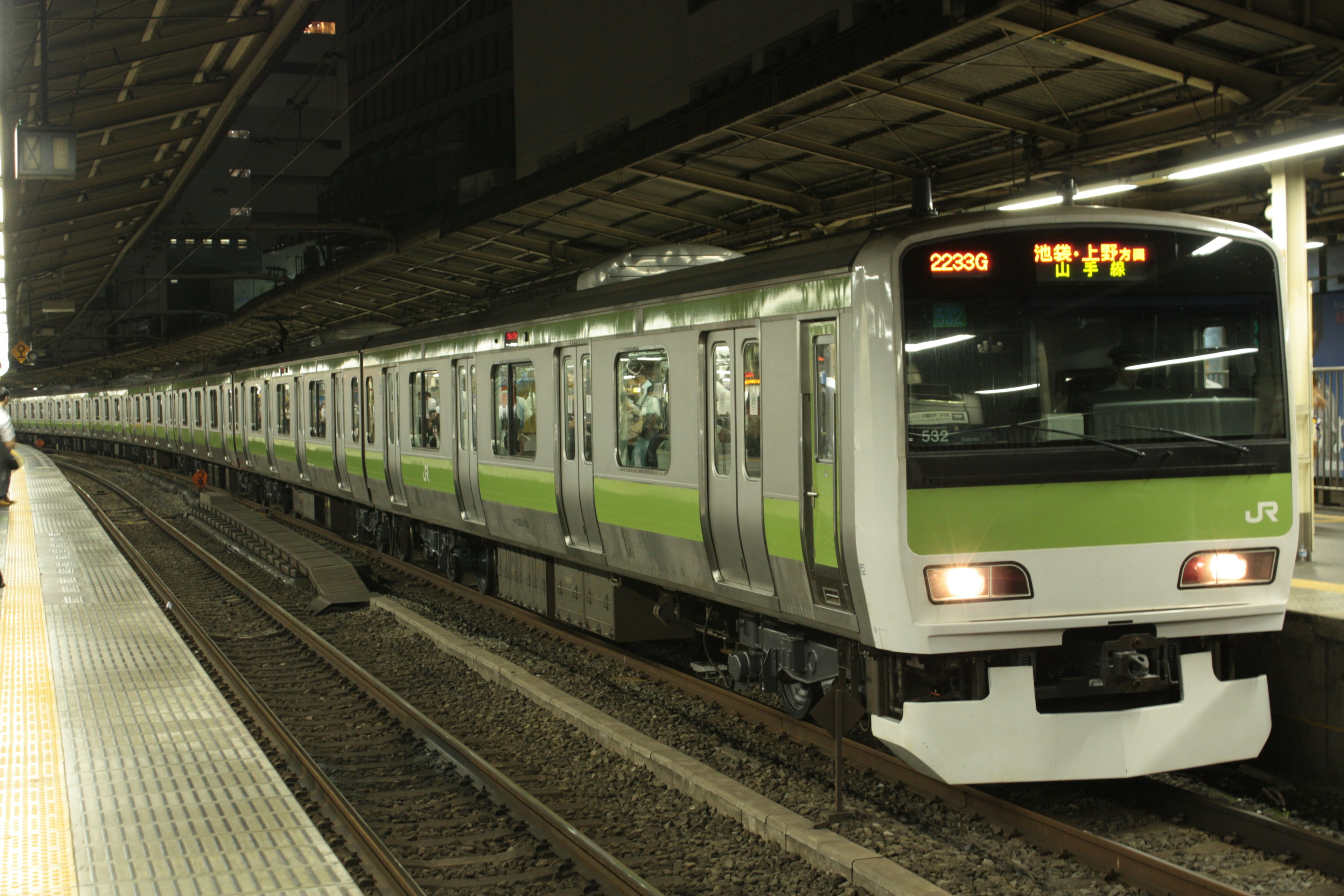 Tren con línea verde de noche en una estación