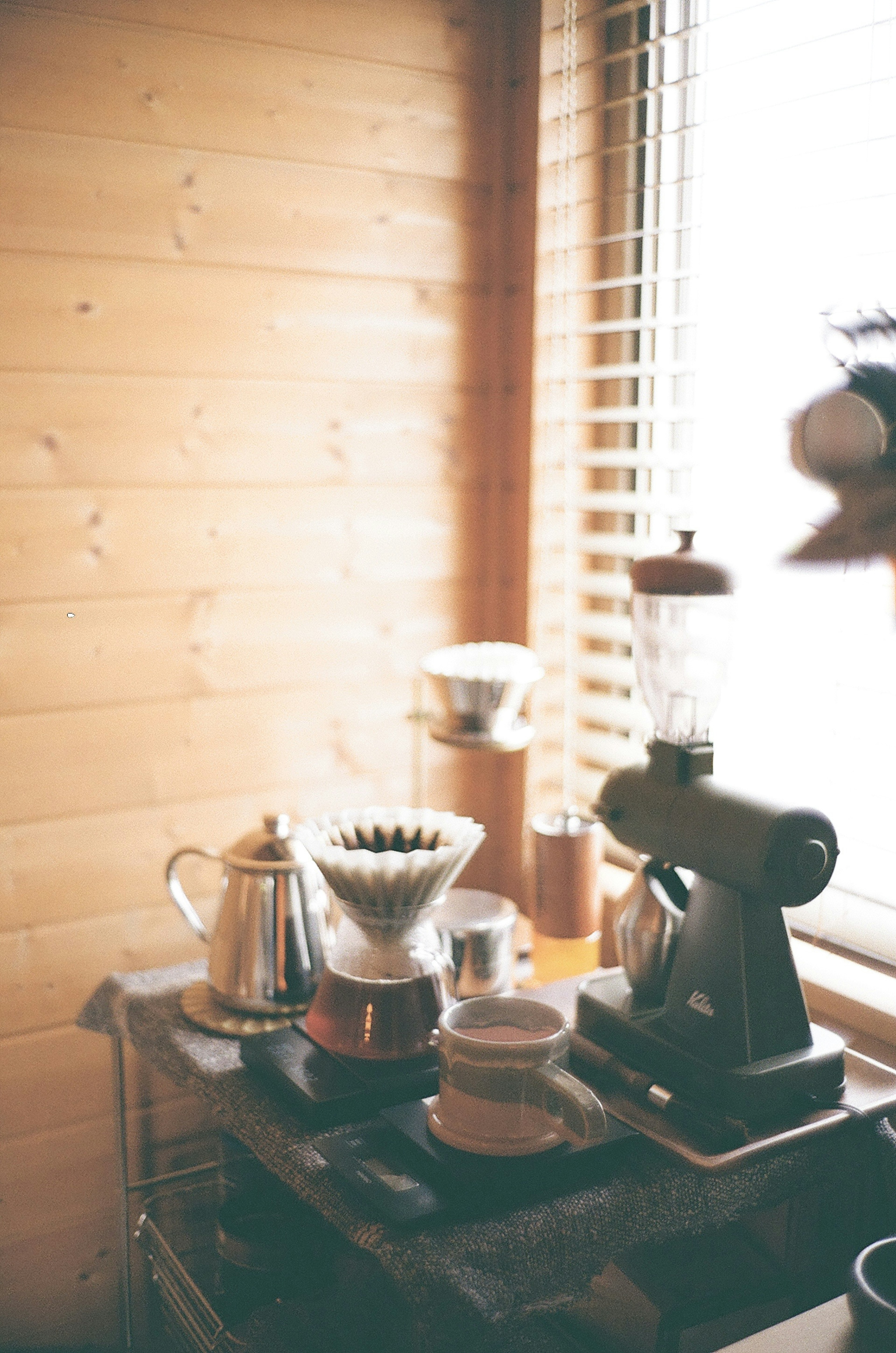 Coffee brewing equipment arranged in a room with wooden walls