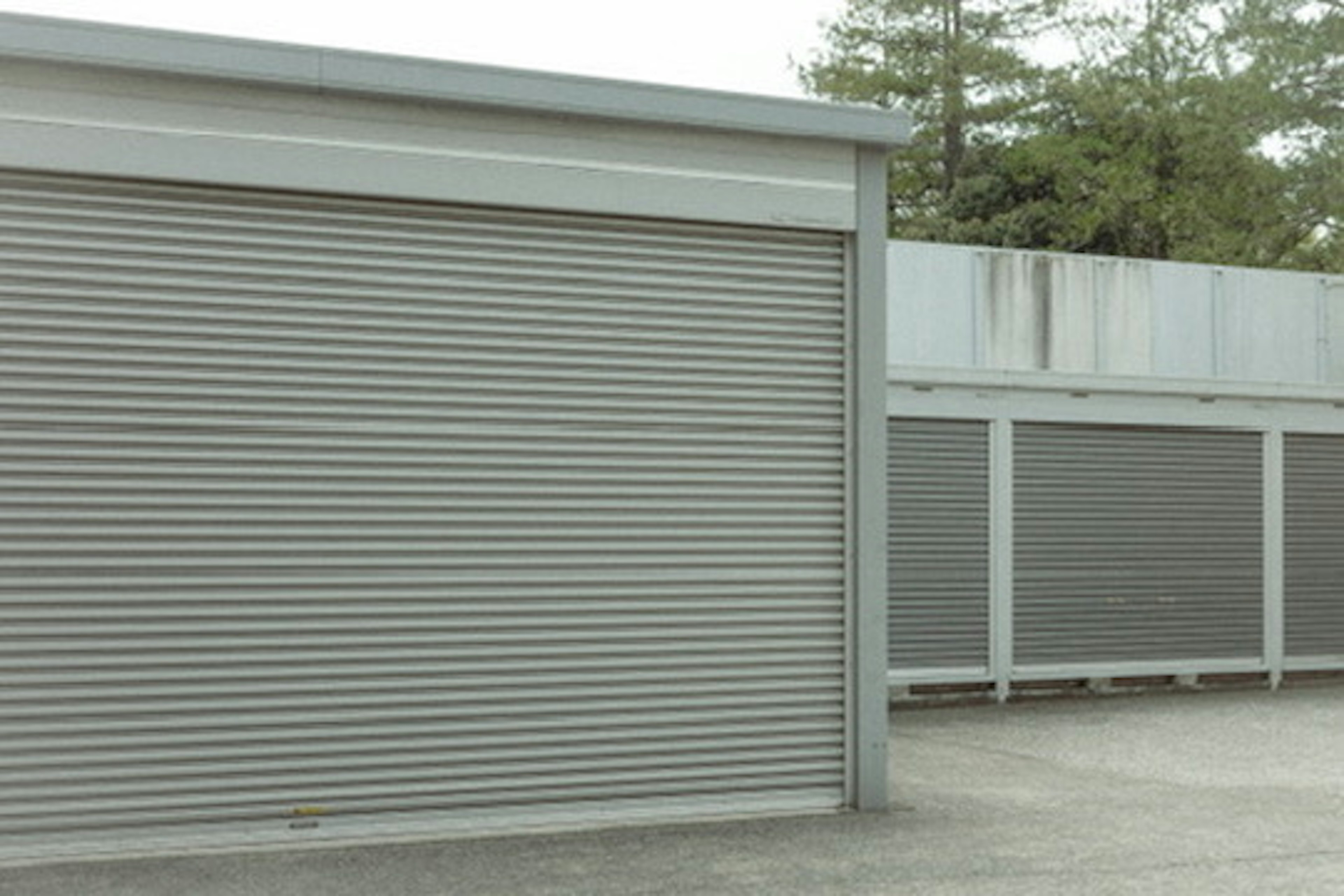 Exterior view of a storage facility with metal roll-up doors