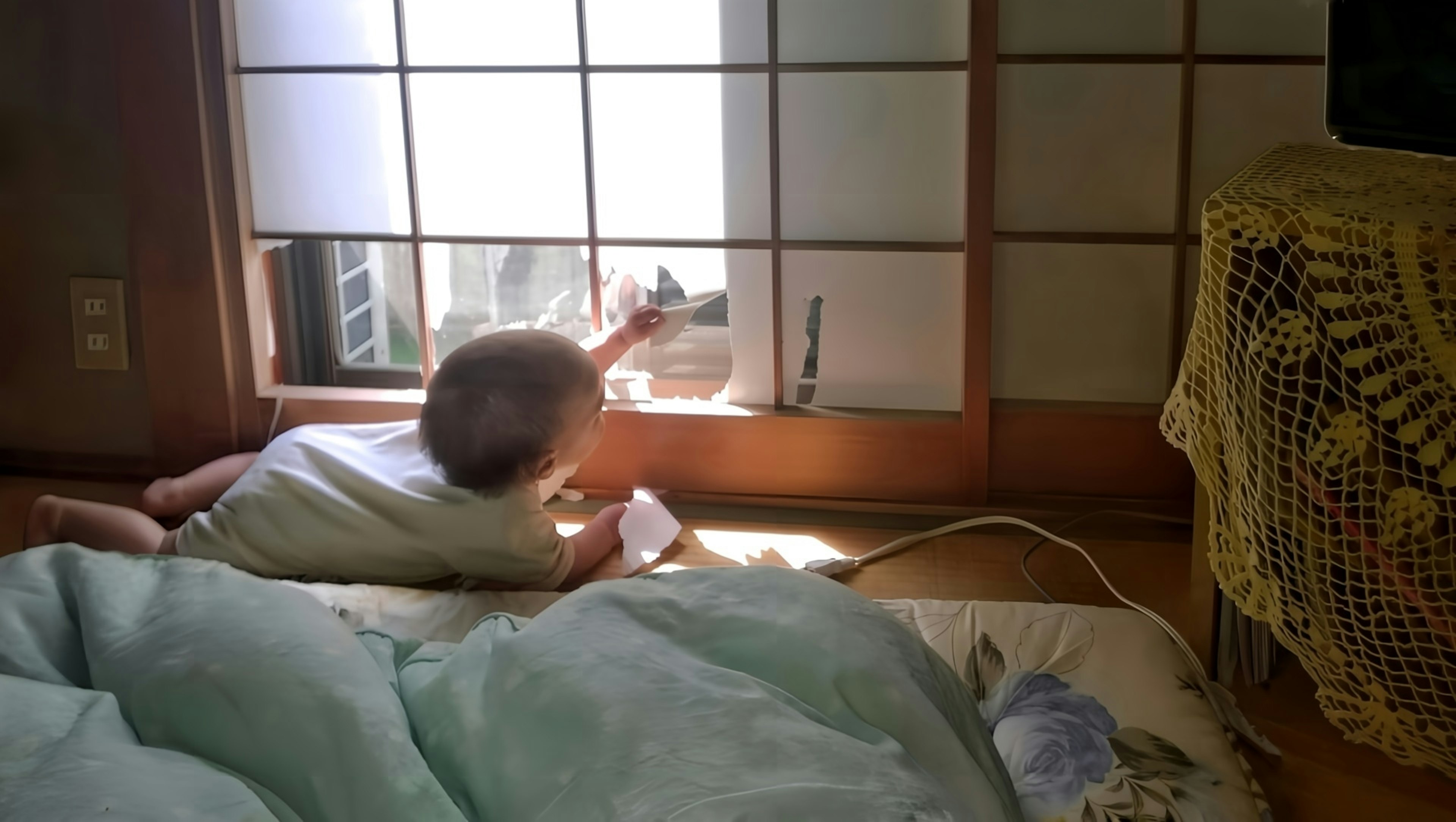 Baby reaching for the window in a traditional room