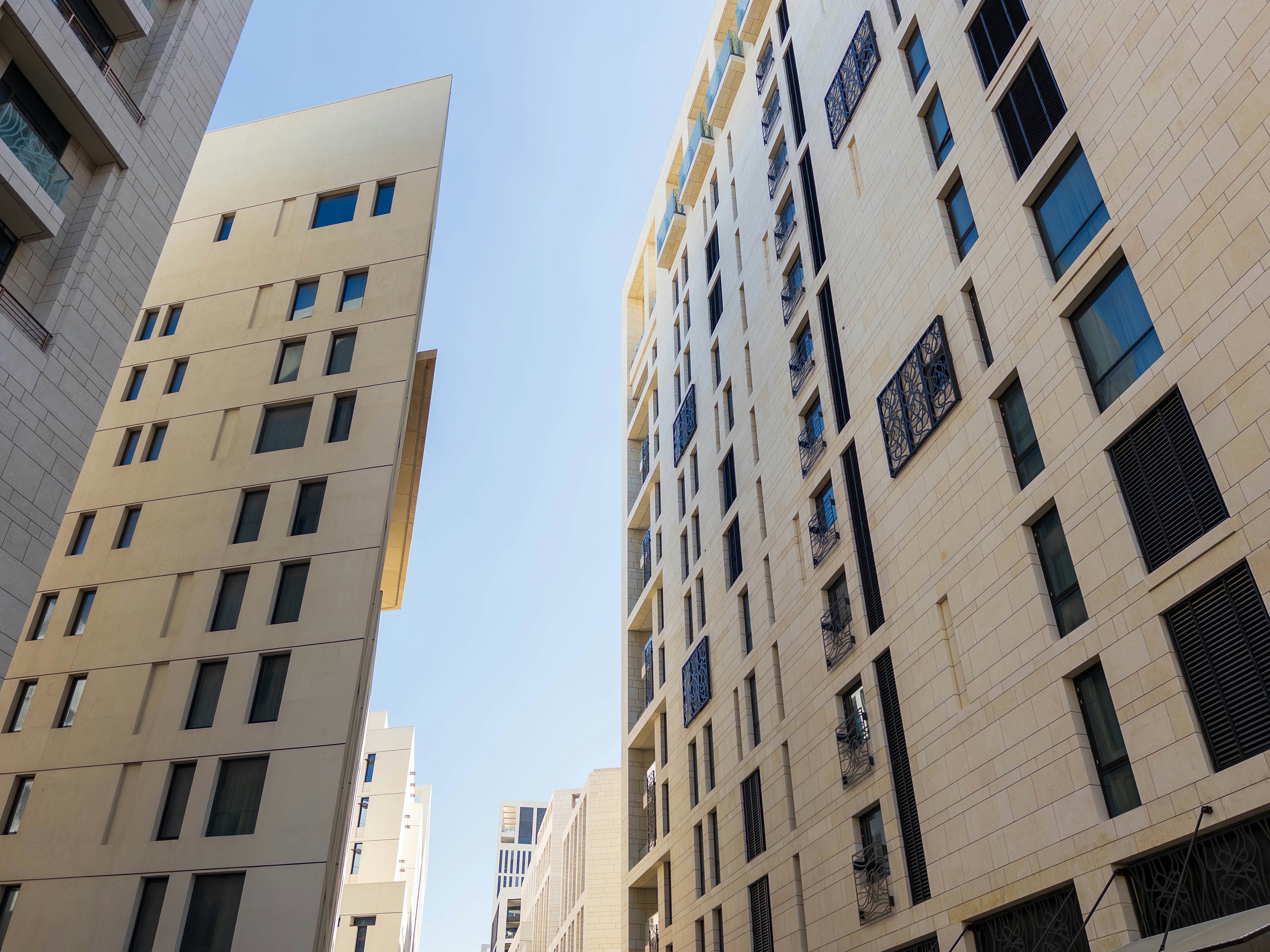 Urban view showing tall buildings with blue sky