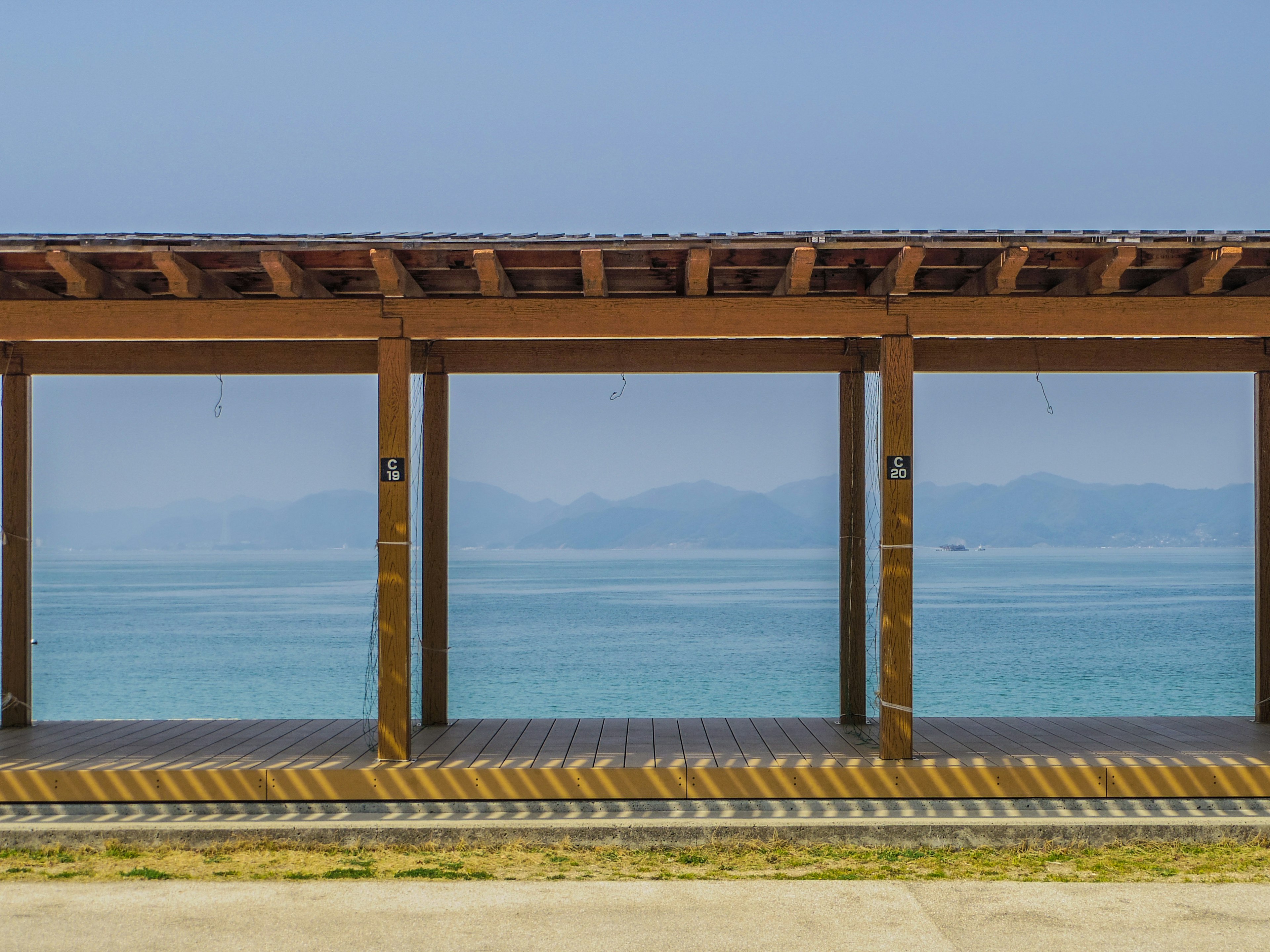 Wooden structure with openings showcasing a sea view