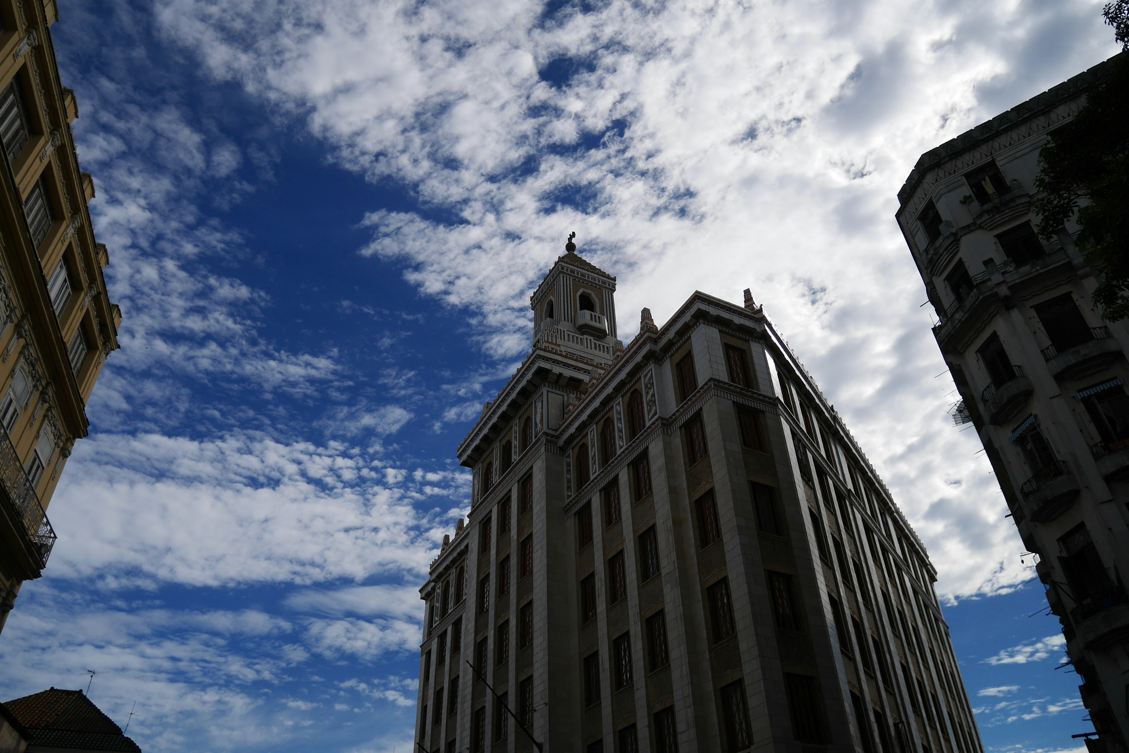 Edificio alto contra un cielo azul con nubes