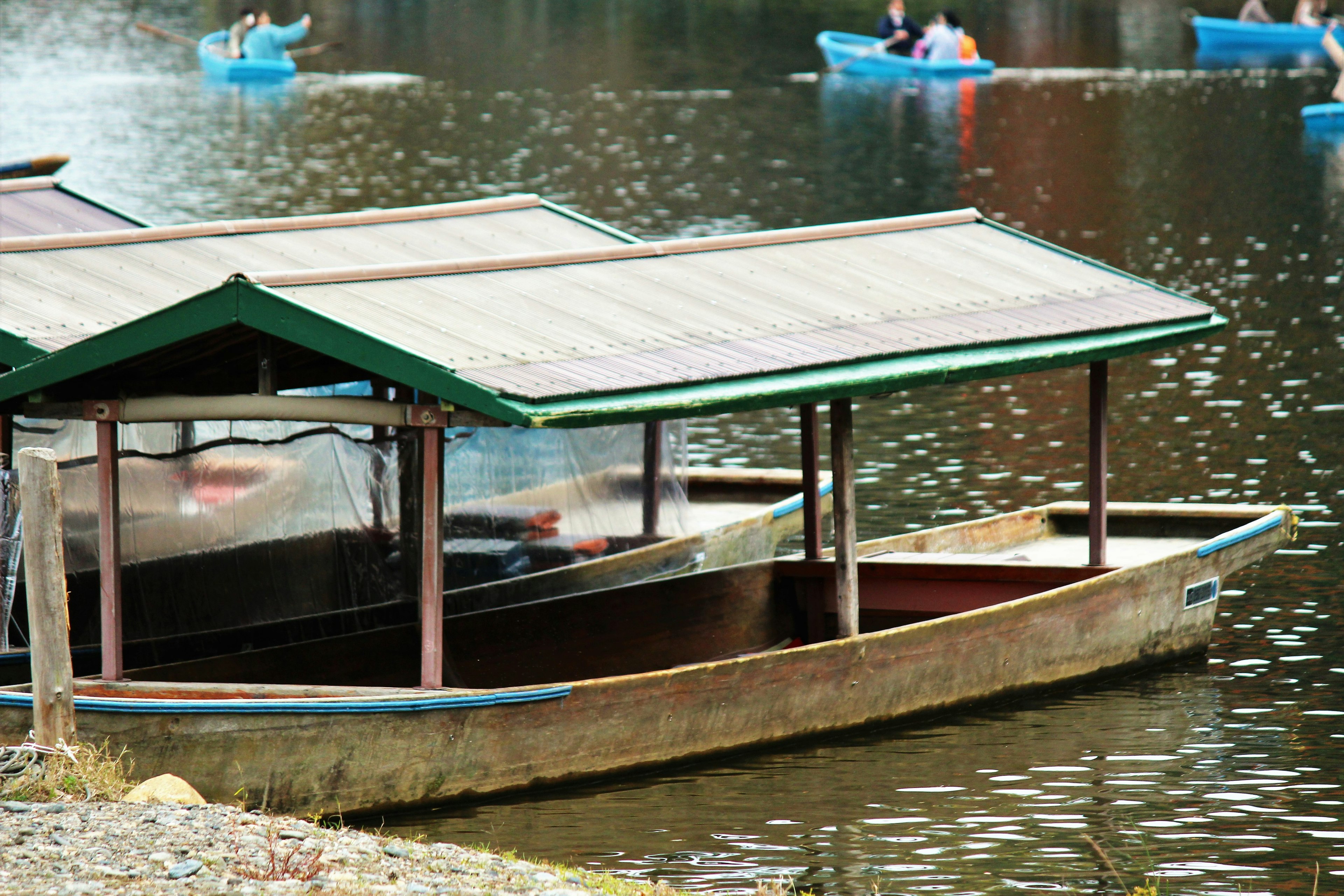 Ein kleines Boot mit grünem Dach, das auf einer ruhigen Wasseroberfläche schwimmt