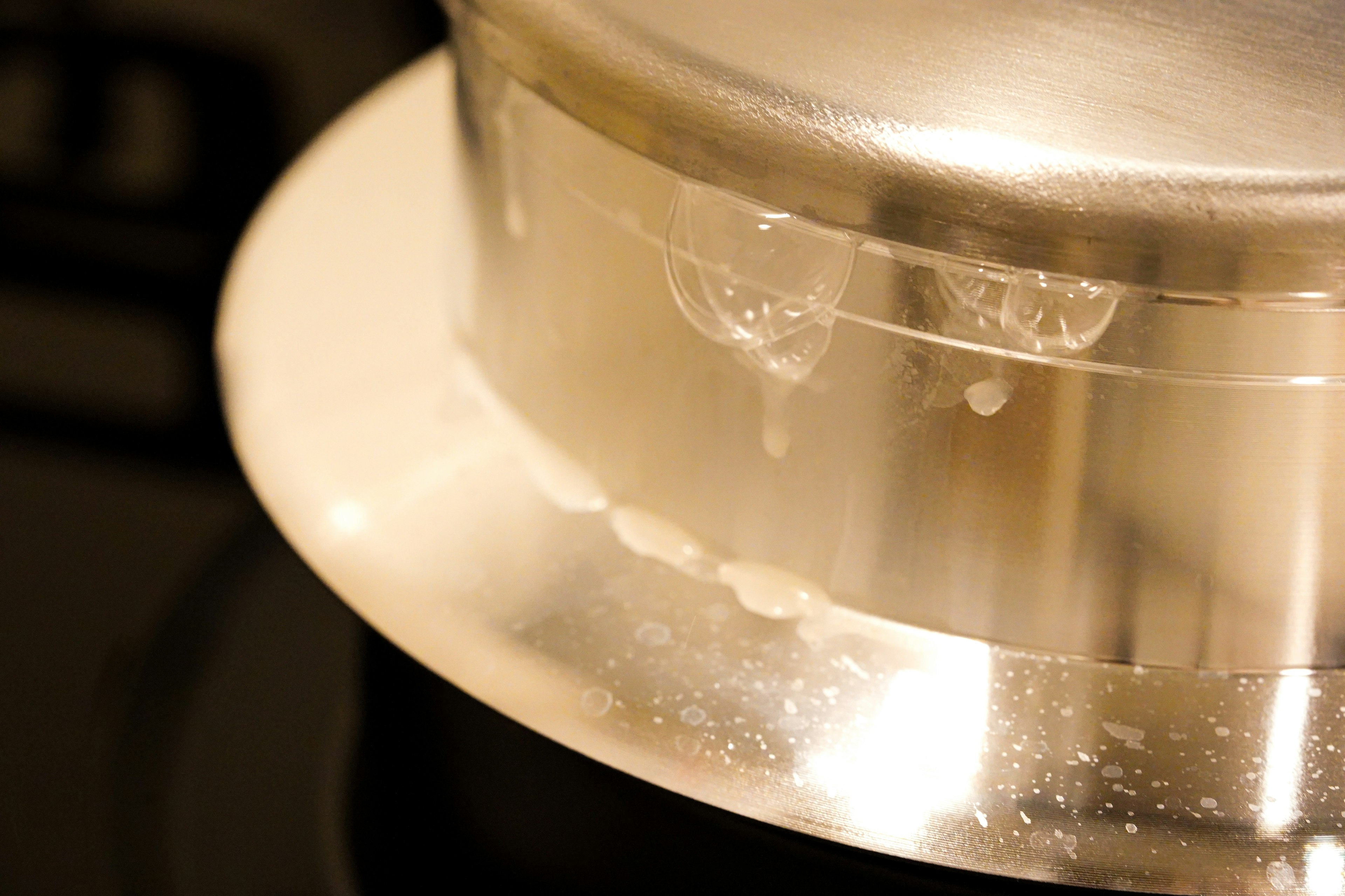 Silver pot with water droplets on the bottom