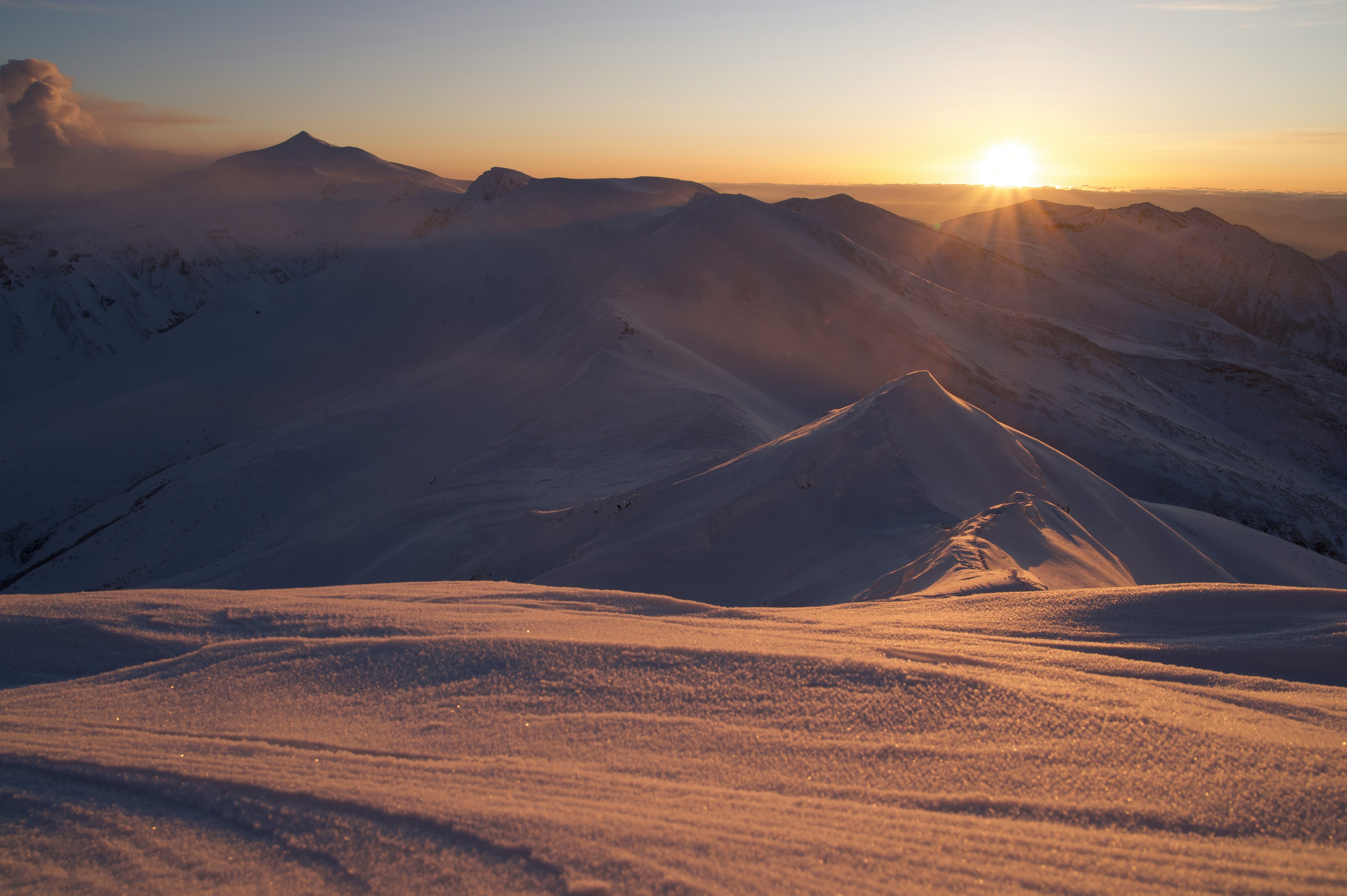 Snow-covered mountains with a stunning sunset