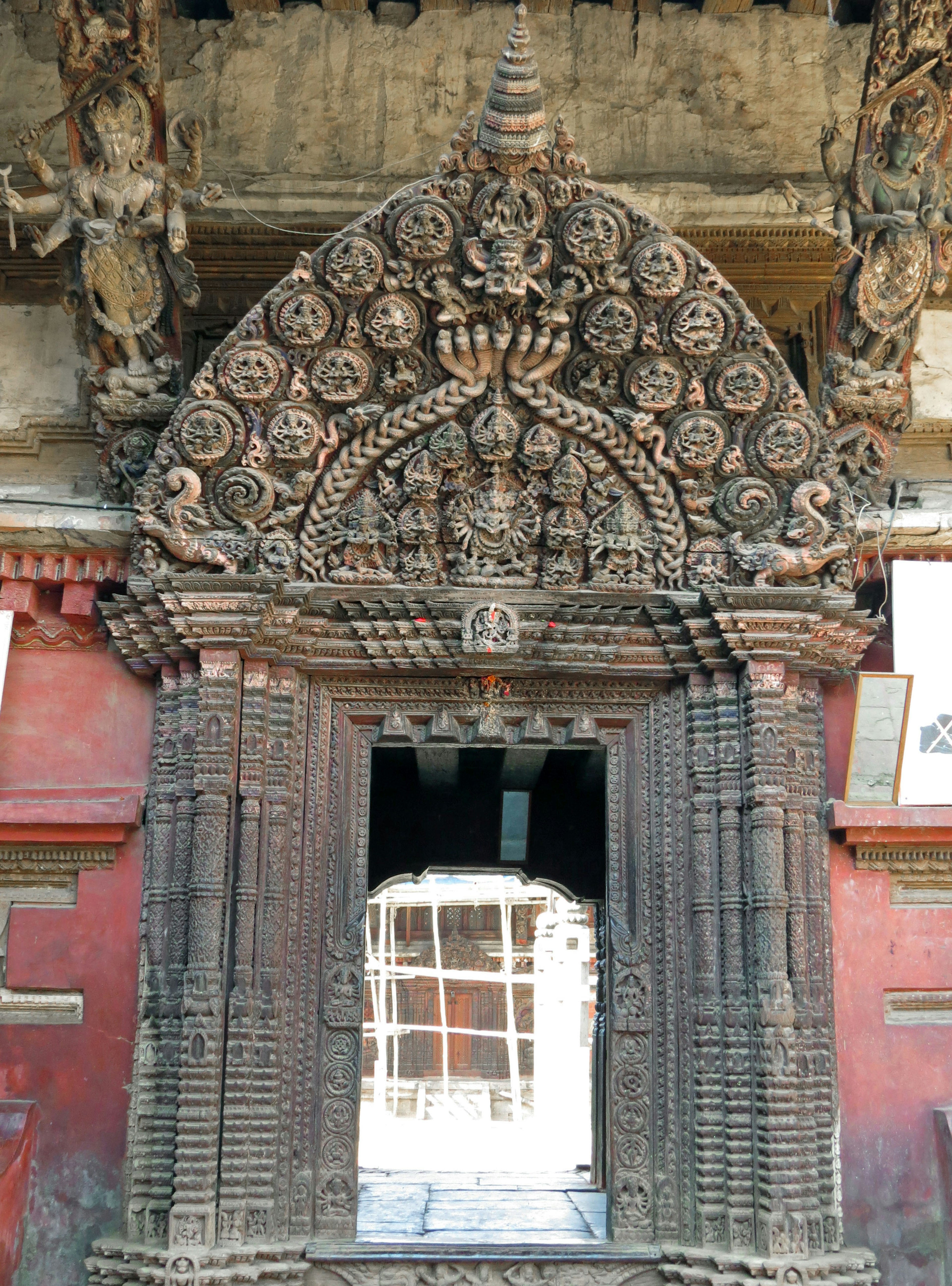 Intricately carved temple entrance arch with a window