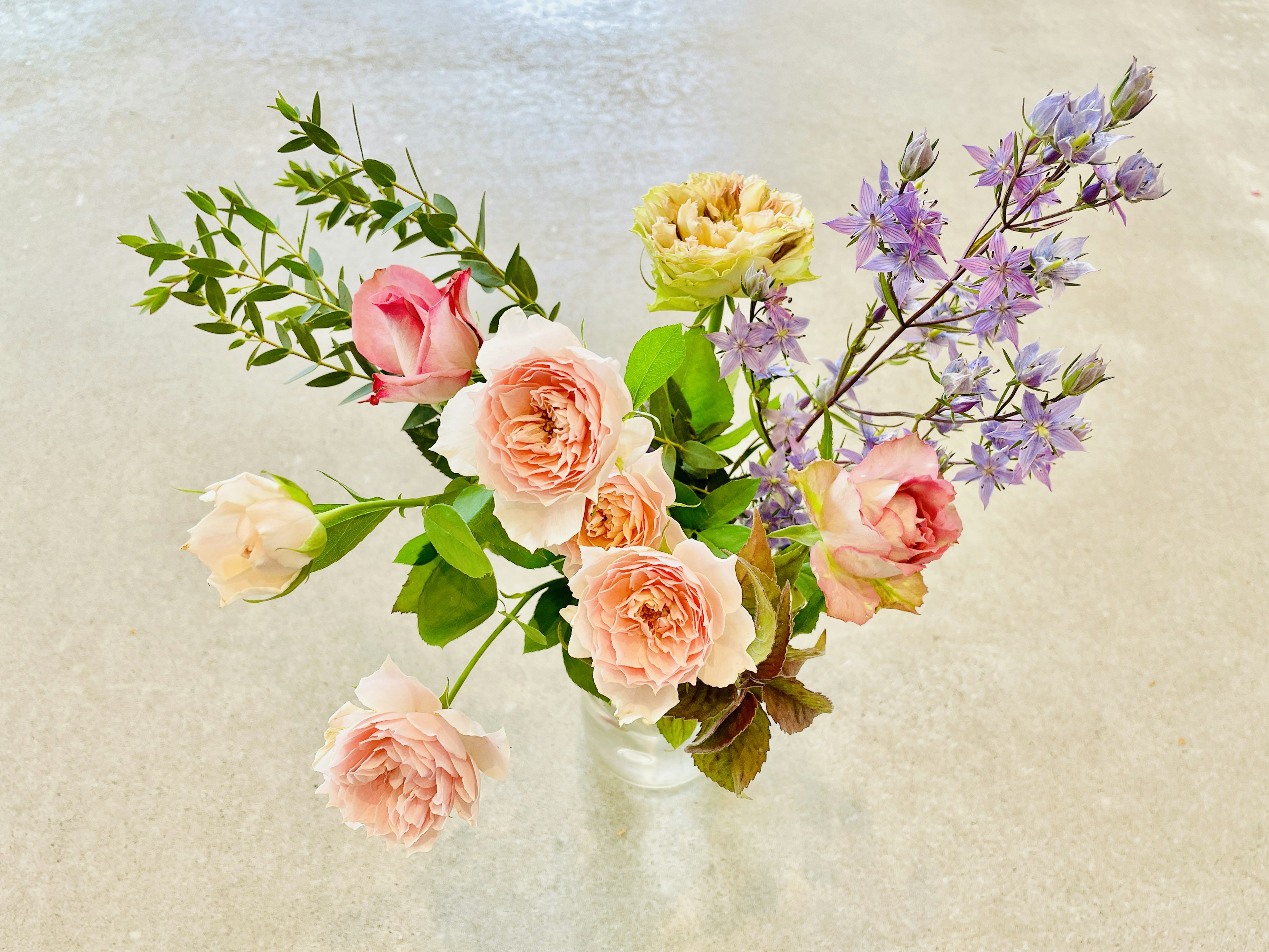 A beautiful bouquet of pink roses and purple flowers