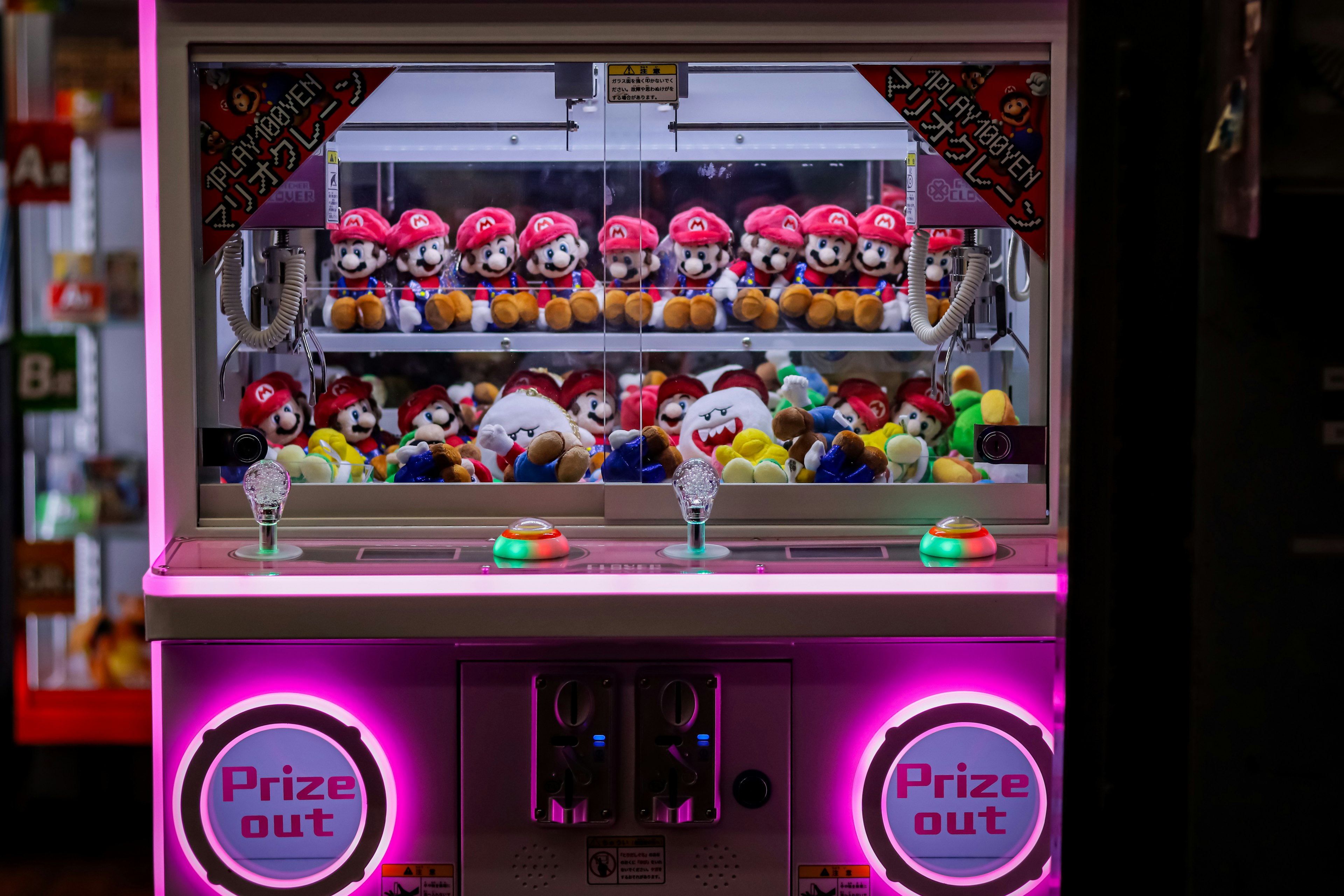 Colorful plush toys and figures displayed in a claw machine