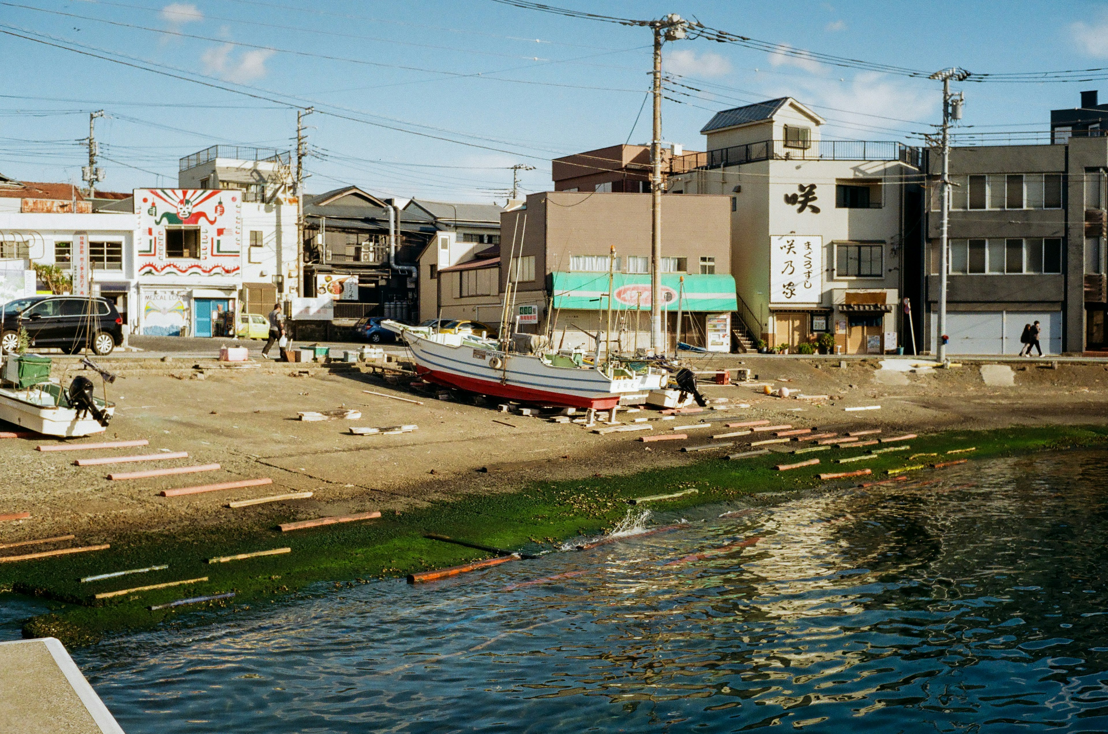 川辺に停泊するボートと周囲の建物が見える風景