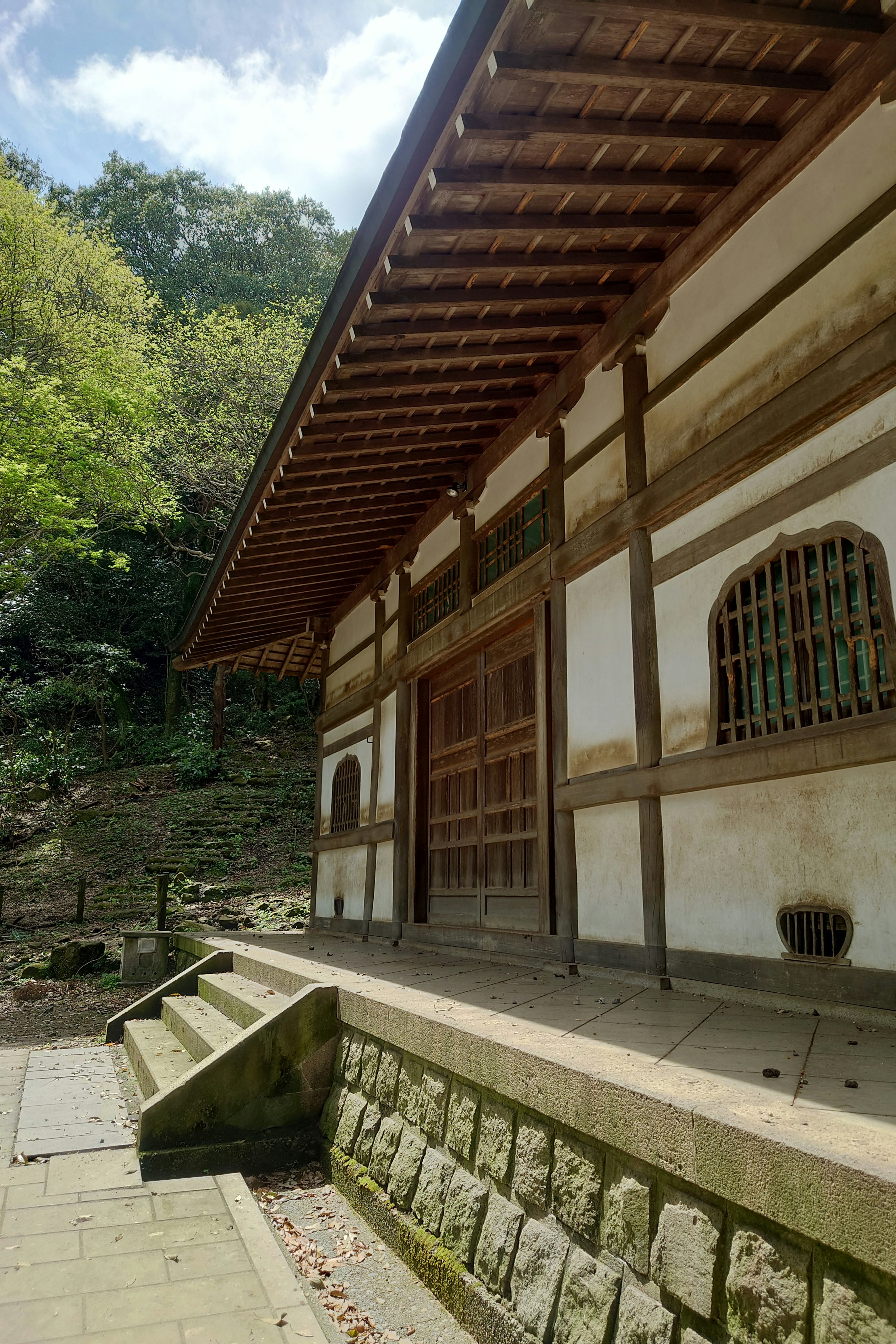 Traditional Japanese building exterior surrounded by nature