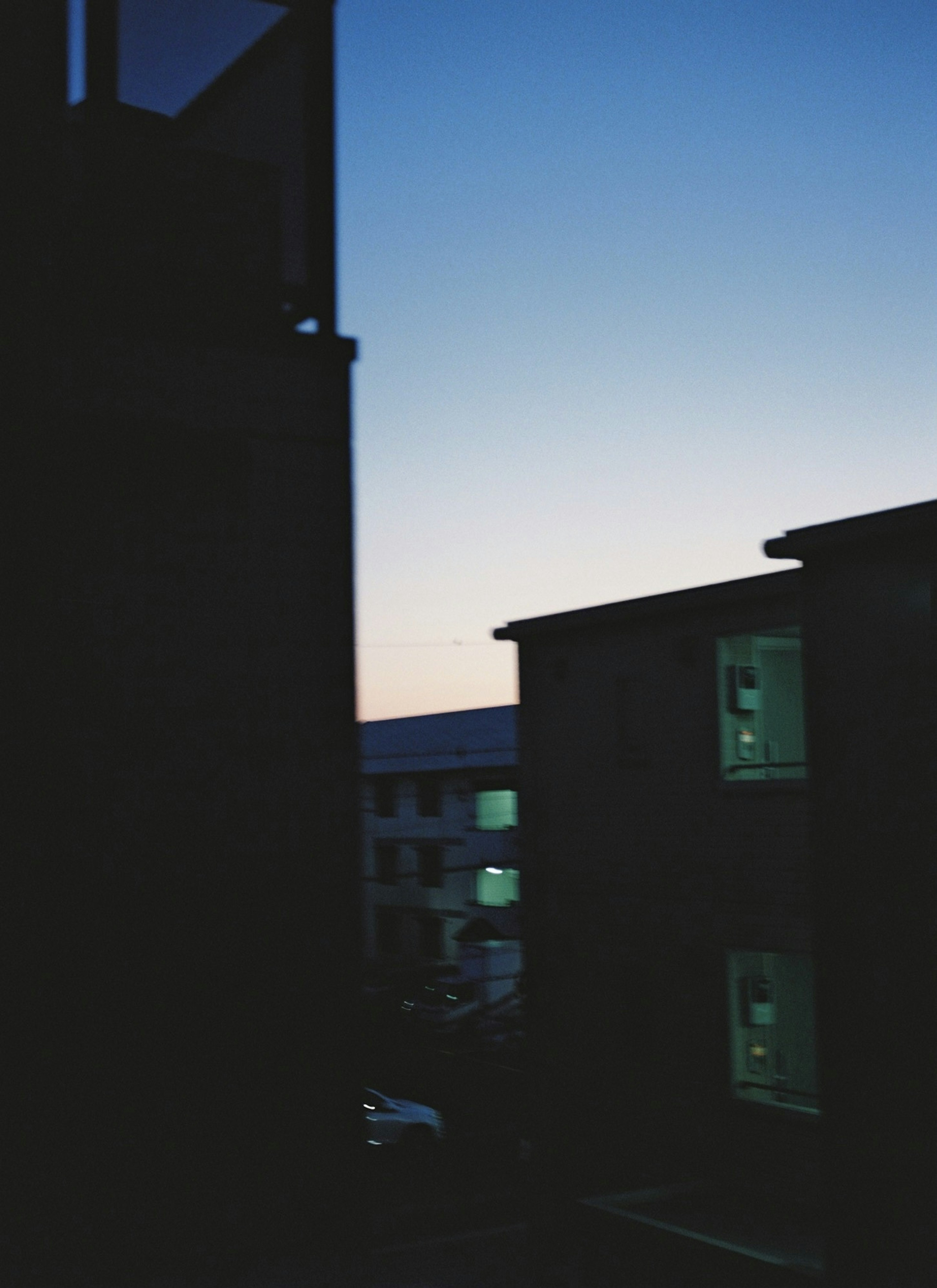 Silhouette of buildings at dusk with blue sky