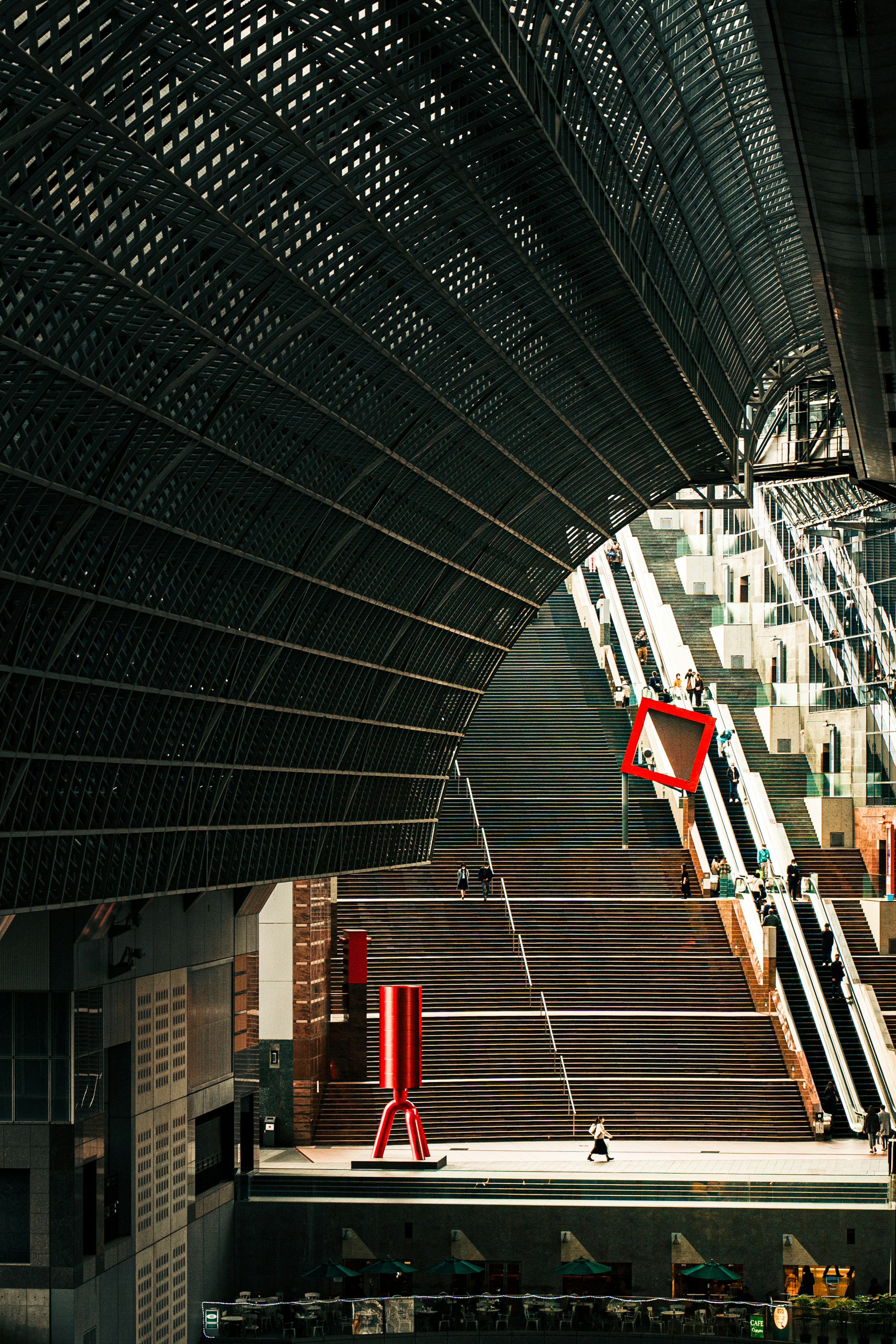 Interior of a modern station featuring a unique roof and stairway design