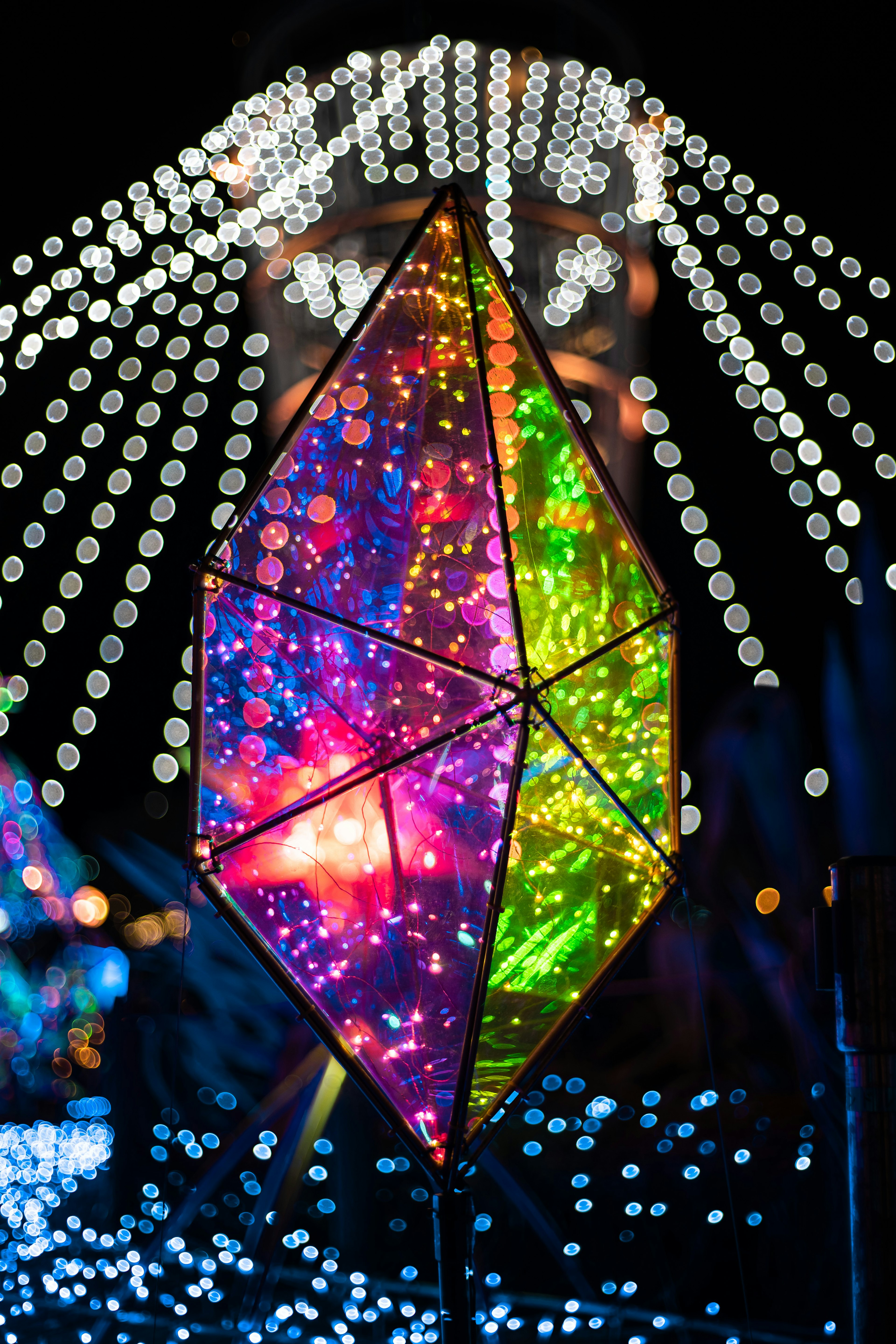 A decorative lamp emitting colorful lights in a night scene