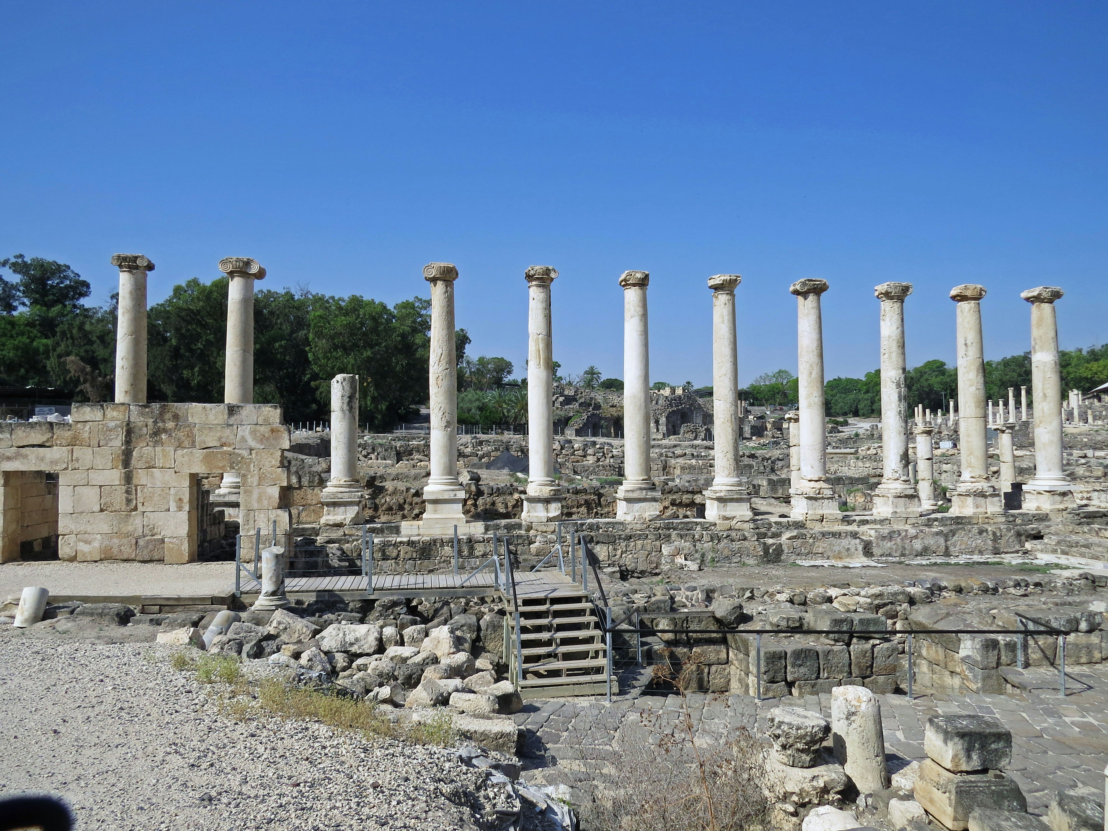 Ancient ruins featuring a row of columns and stone structures