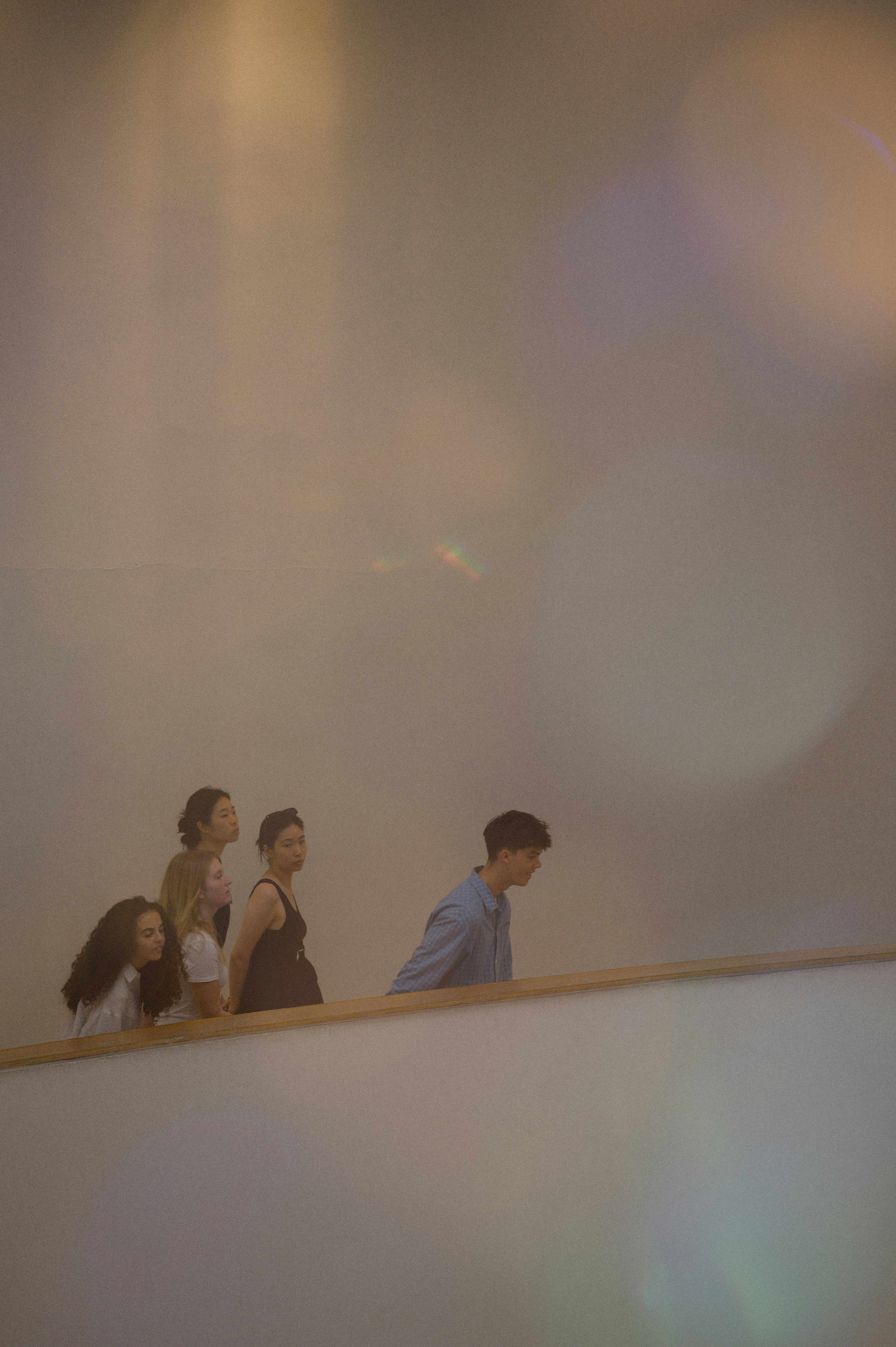 Silhouettes of people ascending stairs with soft light effects