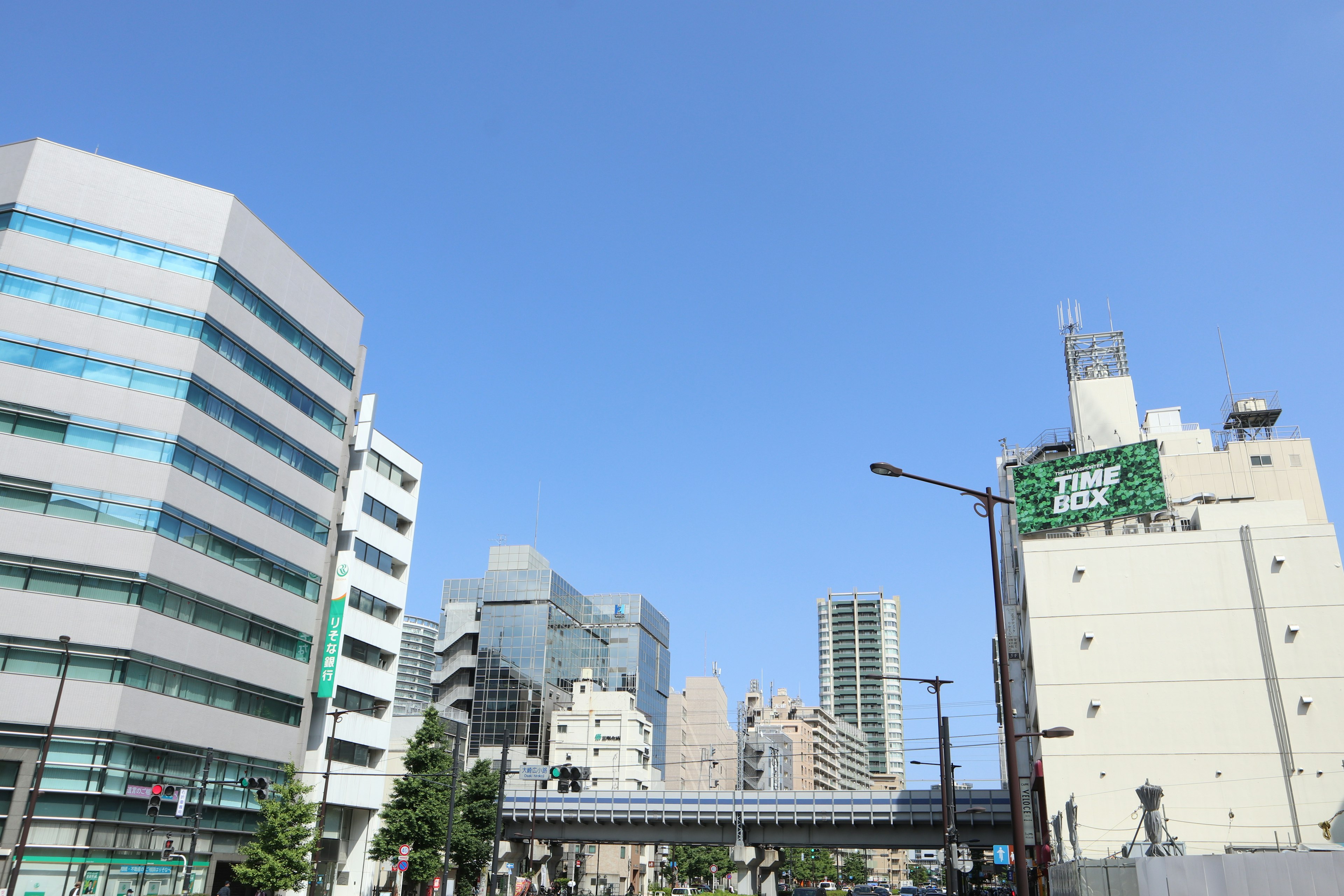 Modern buildings under a clear blue sky with street elements