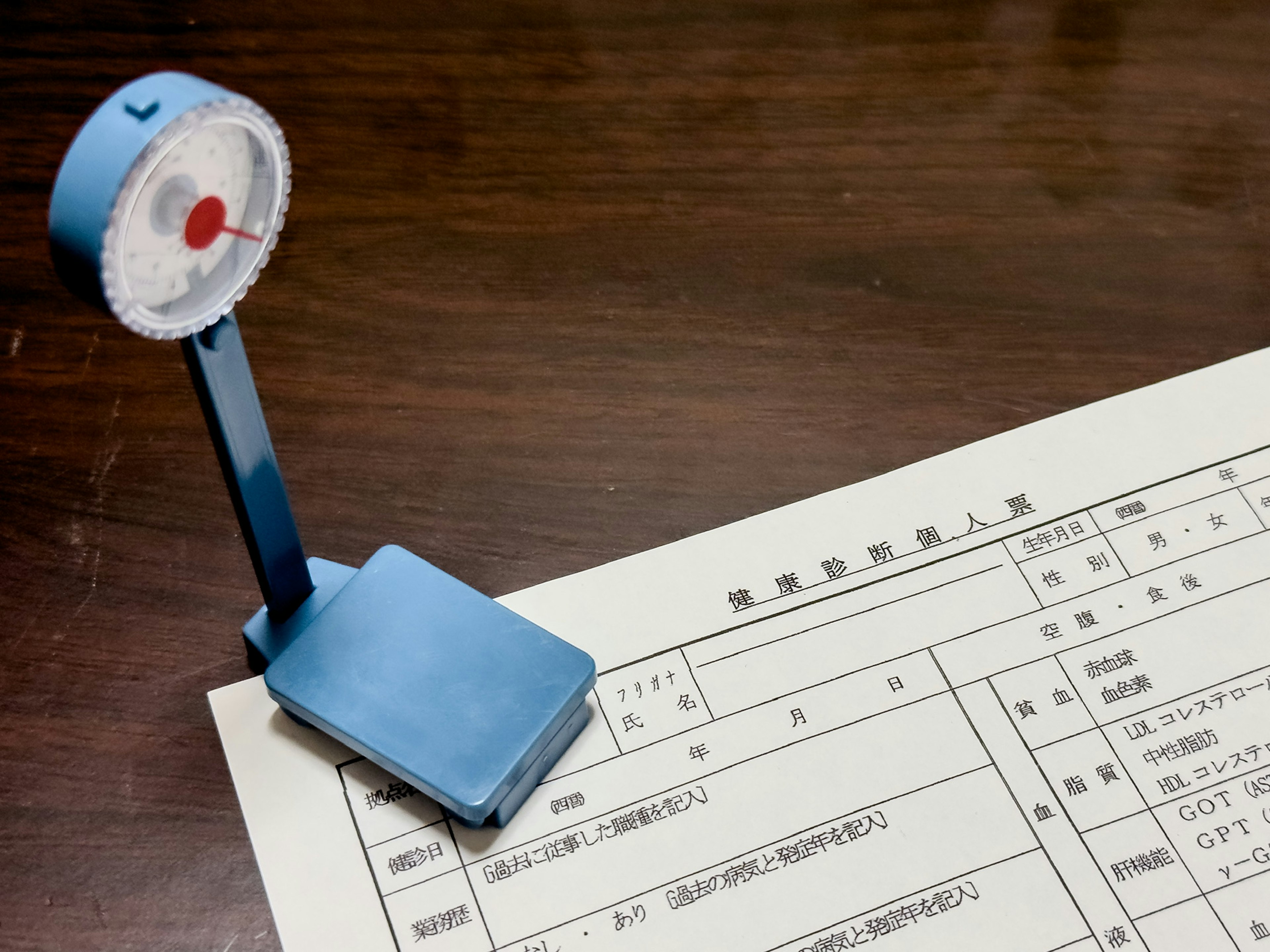 A blue measuring device placed on top of a document