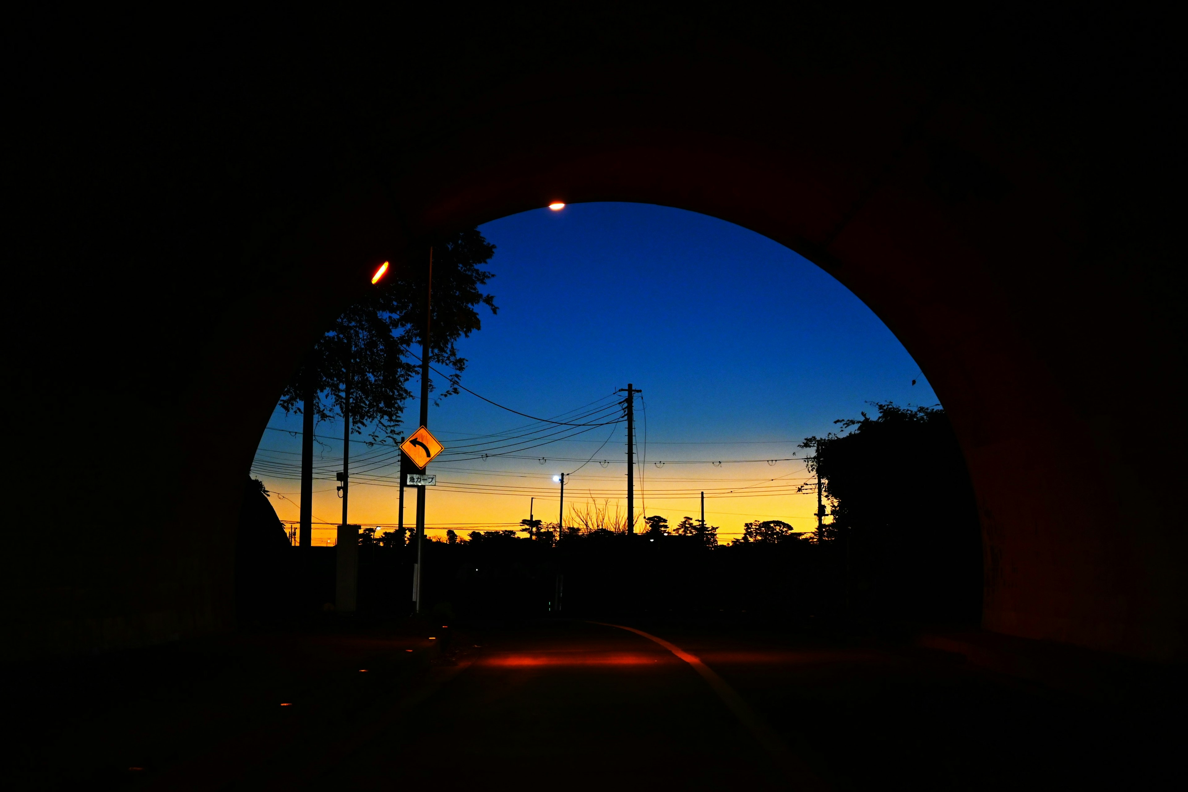 Beautiful sunset sky viewed through the arch of a tunnel