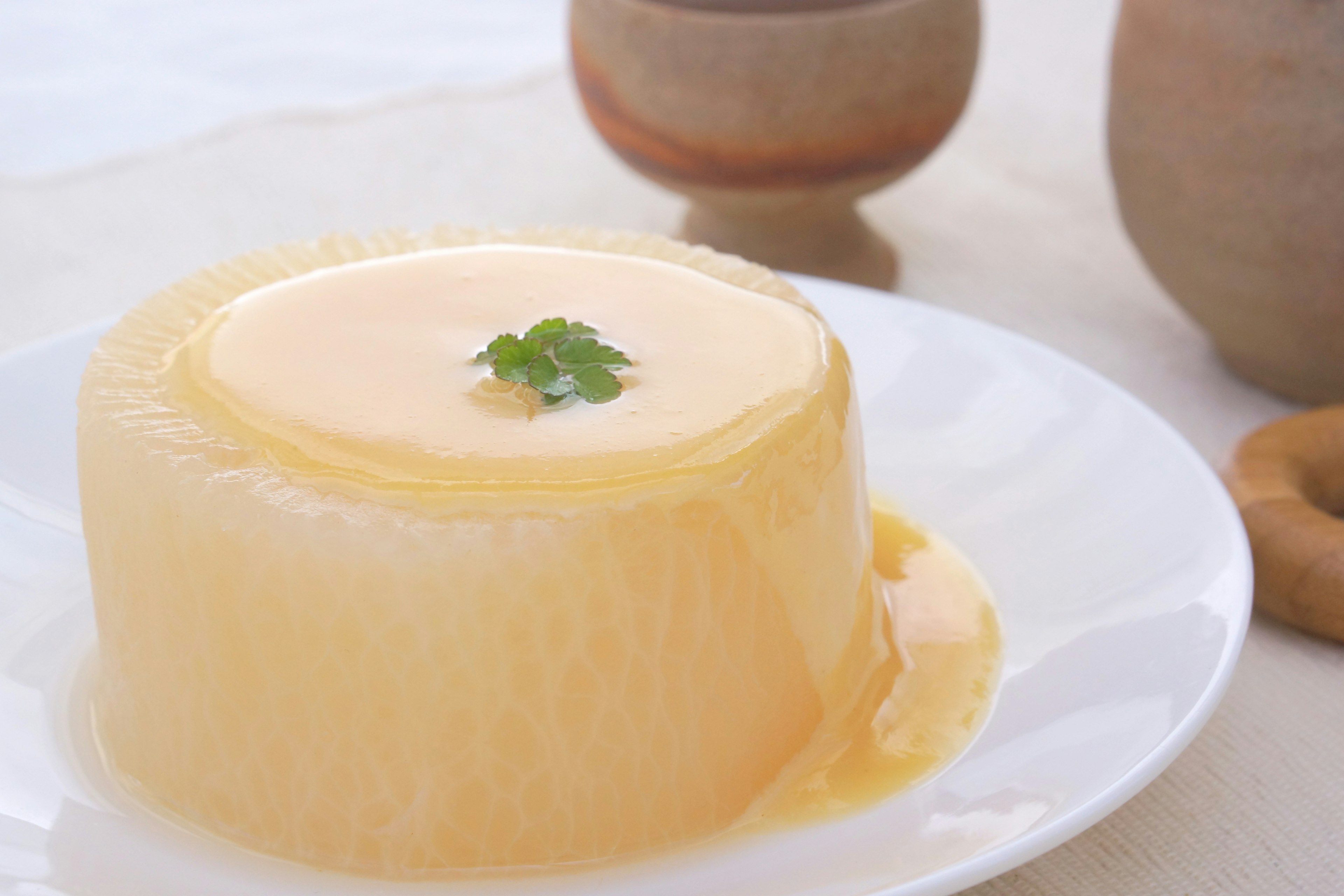 Creamy flan dessert topped with a sprig of parsley