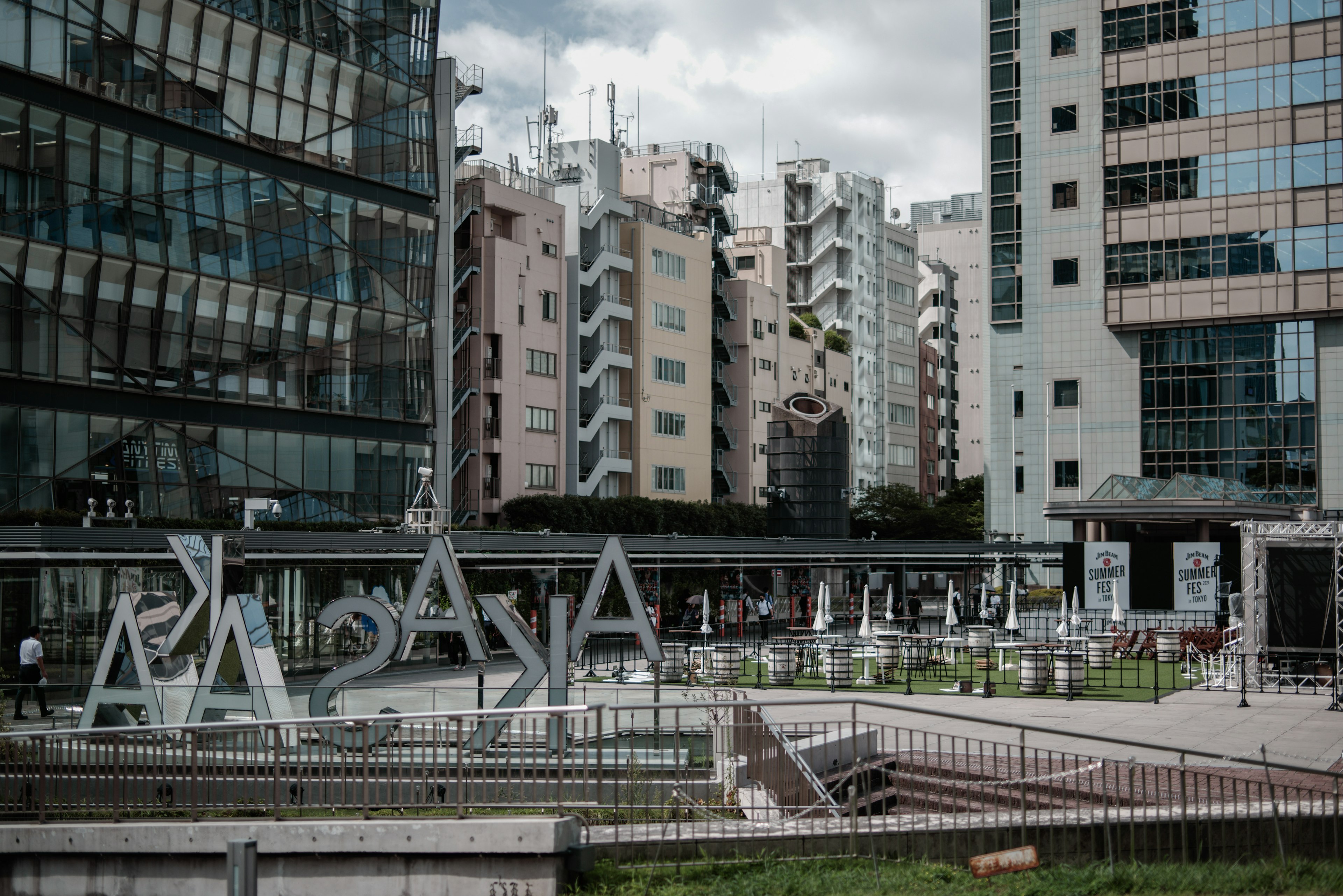 Large letter art in an urban park surrounded by modern buildings