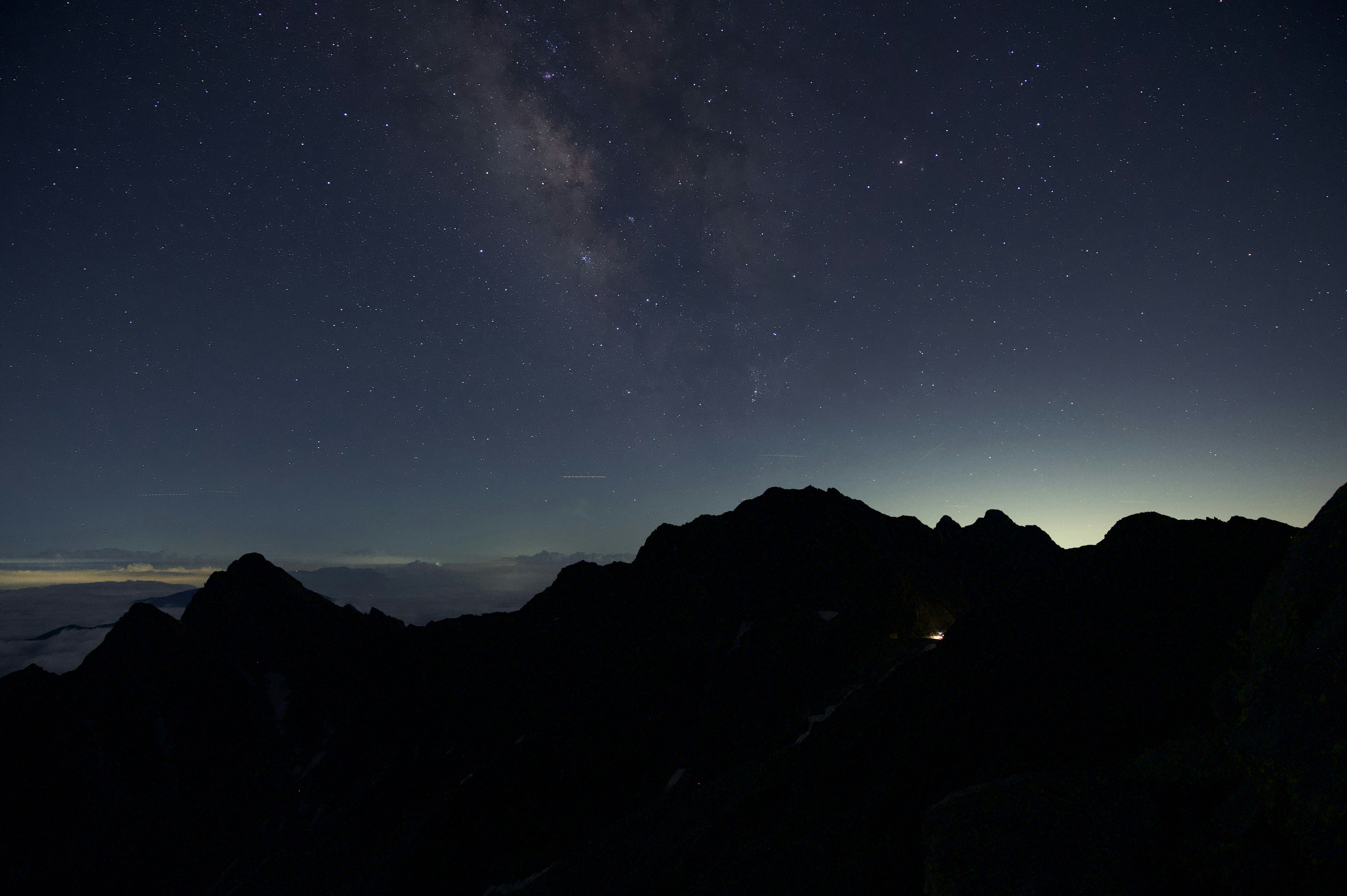 Starry night sky with mountain silhouette