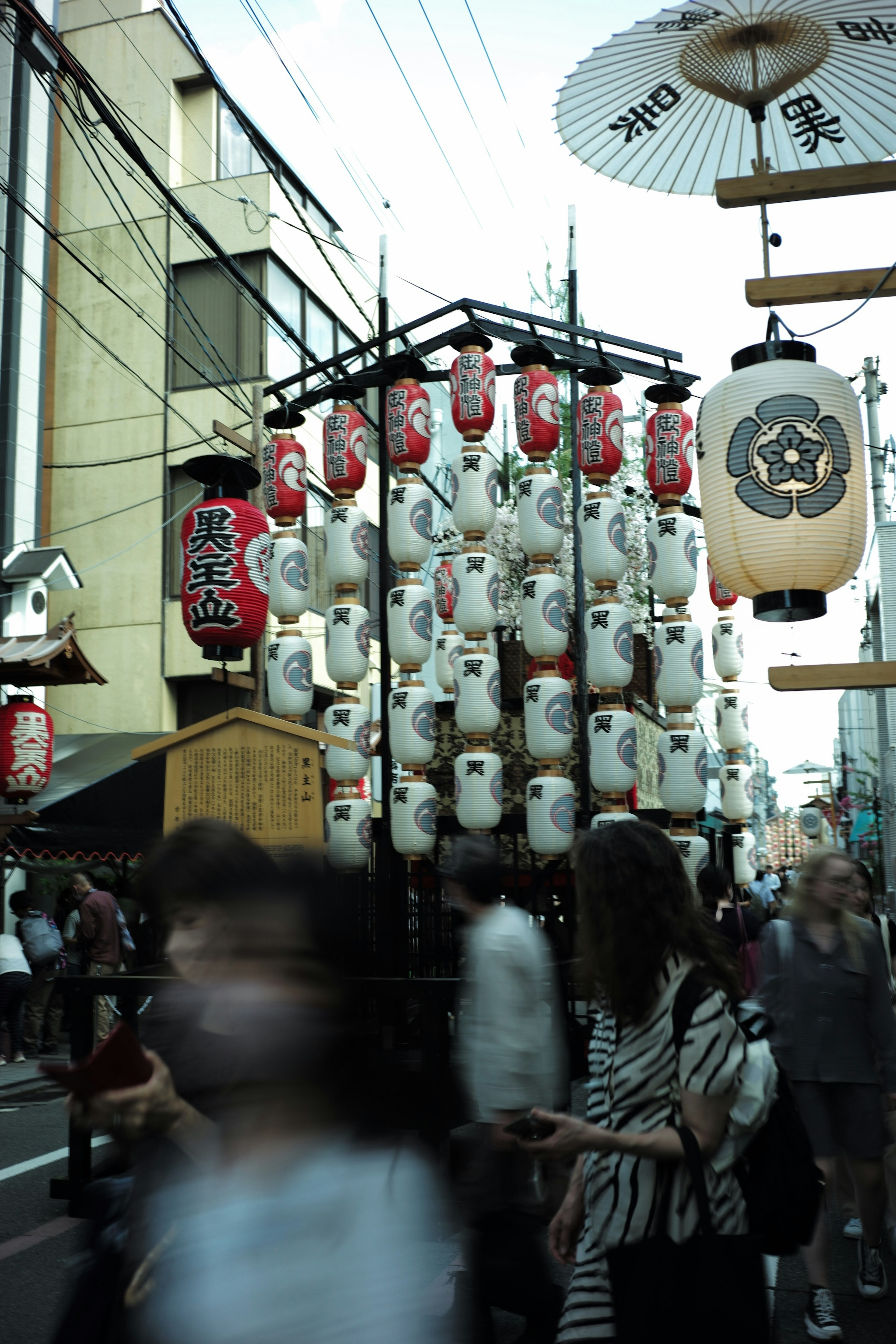 A bustling street scene adorned with numerous lanterns